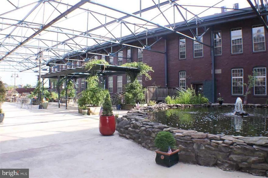 Loft Style condominium located in a historic all brick bldg that was remodeled from a turn-of-the-century silk mill.  Condo features open-flr plan, 18ft high exposed wood beam ceilings, SS appliances, cherry cabinets & hdwd flooring. Common area courtyard featuring barbeques, ponds, eating areas & dog run. Secure parking for 2 cars.