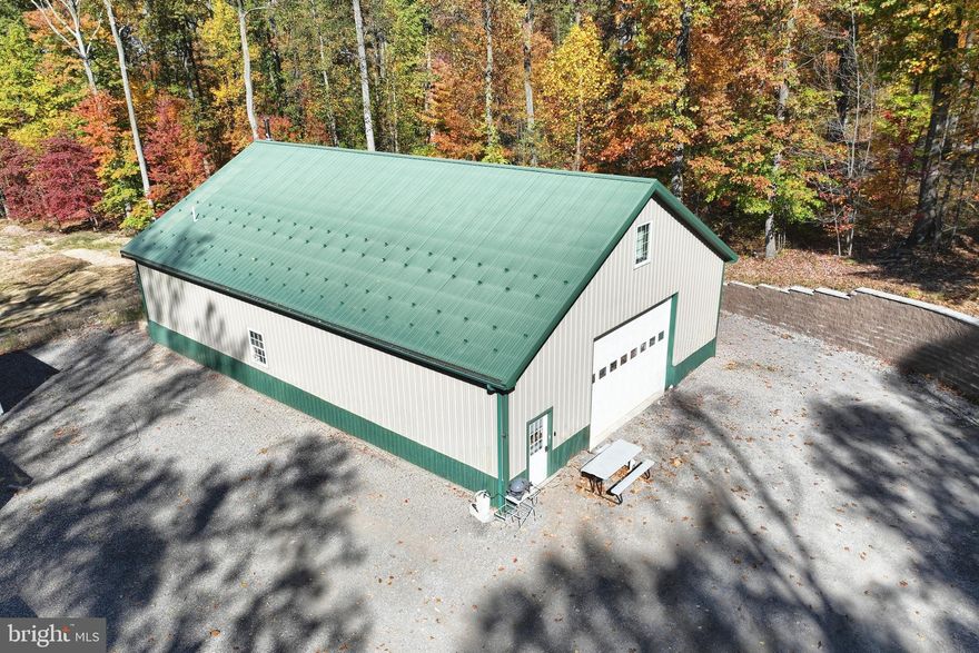 Nestled on 4 serene acres in the picturesque Pigeon Hills of York County, PA, this unique property offers the perfect blend of privacy, convenience, and opportunity. Located just minutes from Codorus State Park and an easy commute to Maryland, this versatile estate features a spacious 2,400 sq. ft. pole building with 1,400 sq. ft. of comfortable living space across two floors. Inside, you'll find a well-appointed 1-bedroom, 1.5-bath layout with family rooms on both levels, creating a warm and inviting atmosphere. The building also boasts 2,000 sq. ft. of garage space, providing ample room for storage, a workshop, or hobbies. With plenty of parking for a boat or camper, this property is ideal for outdoor enthusiasts. Looking to build your dream home? A 2,100 sq. ft. foundation is already in place across the street, ready for your vision to come to life. Don’t miss this rare opportunity to own a one-of-a-kind retreat in a peaceful yet convenient location!