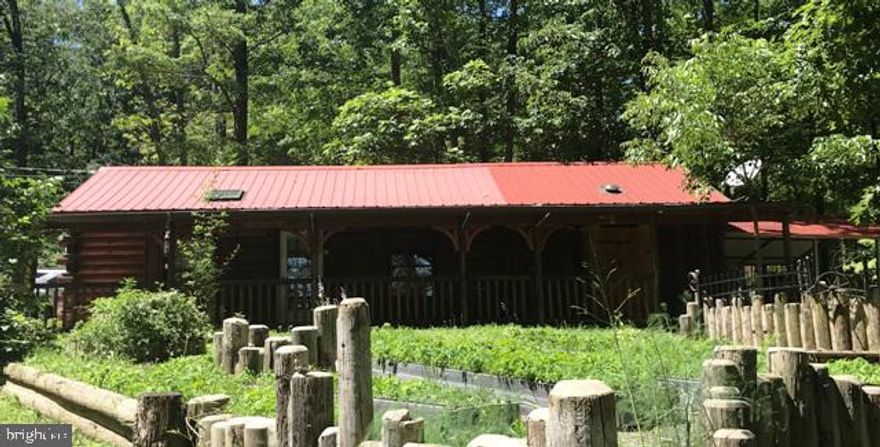 This cabin is a One of a Kind!  If you are looking for some seclusion with convenience in close proximity, then look no further!  This cabin consists of one large room with kitchen, semi-private bath, a Murphy bed and a large enclosed porch.  In the main room there is a propane fireplace.  There is a washer dryer hook-up in the bathroom and it has electric heat and air conditioning.  The cabin has a large, covered patio and two out buildings.  There is plenty of parking on the driveway.  This cabin is on nearly three quarters of an acre just a short distance from Route 28 in Short Gap.  It can be a year round home or a seasonal cabin.