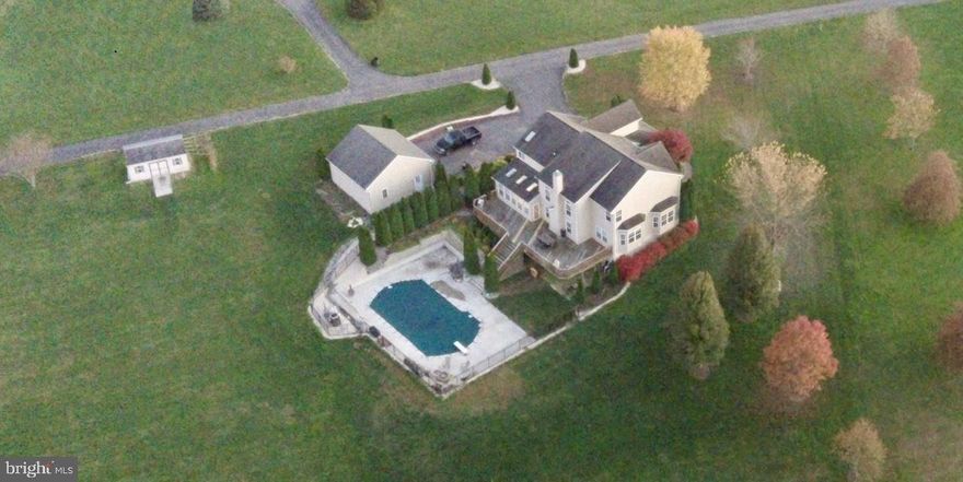 Welcome to your private retreat in picturesque Harford County! Tucked away on 2 peaceful acres, this stunning 5-bedroom, 3.5-bathroom ,  home offers the perfect blend of space, style, and serenity—set well back from the main road for added privacy.

Step inside to a beautifully maintained interior featuring 9-foot ceilings, seamless bamboo flooring (installed 2019), and a dramatic foyer and main family room with soaring two-story ceilings, anchored by a striking gas fireplace framed by a grand stone wall and separate office.  The kitchen is well-appointed with stainless steel appliances, ceramic tile flooring, a center island, and opens to a bright sunroom with skylights and wraparound windows.

The layout includes 4 bedrooms and 2.5 baths on the main and upper level including  master bedroom  with sitting room, walk in closets and full master bath with jacuzzi tub and separate shower, plus a fully finished walkout basement offering a 5th bedroom, a full bathroom, and over 1,000 sq. ft. of flexible living space—perfect for guests, entertaining, or extended family.

Additional conveniences include a first-floor laundry room with utility sink, storm doors on both entrances, and efficient systems like propane heating, a two-zone HVAC setup, and a 500-gallon owned underground propane tank.

Car lovers and hobbyists will appreciate the 5 garage spaces: a 3-car attached garage (insulated and finished with built-in cabinetry), a 2-car detached garage with 11-foot ceilings (insulated and drywalled), and an additional workshop space in the detached garage—ideal for projects, storage, or a home business.

Outdoors, enjoy your own backyard oasis with a heated in-ground pool (installed 2017), surrounded by a wide concrete patio, privacy tree line, and a 20x12 storage shed. Recent upgrades include a new roof (2025) and new decking (2024).

This home runs on well water (15 GPM yield) with a neutralizer, softener, and reverse osmosis system, and features a regularly serviced septic system (last serviced December 2024).

This is more than just a home—it’s a private, peaceful lifestyle with all the space and features you’ve been looking for.