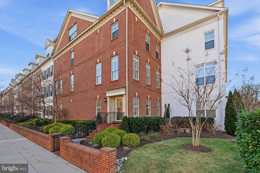 Experience refined urban living in this meticulously maintained 5-bedroom, 4.5-bath luxury end-unit townhome ideally located near Ballston. The home’s interior exudes luxury with plantation shutters on all windows and custom built-ins in all bedroom closets on the upper levels and the garage. This residence showcases thoughtful updates, craftsmanship, and functionality. Imagine coming home to a space where everything has a place and daily routines feel effortlessly organized. 
The first level features a bedroom with a full bath and a dedicated office, offering a flexible space that works just as well for remote work as it does for hosting overnight guests. This level also provides access to the two-car garage, equipped with dual 240-volt EV charging outlets and generous custom built-ins for maximum utility.
At the heart of this four-level home is the second level, designed for both entertaining and quiet relaxation. The living room boasts a KozyHeat Nordic 36 gas fireplace with a custom-designed wall, creating a sophisticated focal point. This space opens directly into the stunning designer kitchen renovation (late January 2024) — a chef’s dream that serves as the center of the home. Anchored by Calacatta Oro Alleanza quartz countertops and custom Brighton cabinetry, the kitchen features a 48” Sub-Zero French door refrigerator, 36” Wolf electric induction cooktop (gas line available), Wolf steam and convection wall ovens, Best Co. downdraft, Sharp Easy Wave drawer microwave, Bosch dishwasher, and a quartz Elkay 33” sink. This impressive culinary space leads seamlessly into the dining room featuring double crown molding and chair railing, which opens to an updated balcony deck with Trex flooring. Whether preparing meals with ease, hosting friends, or grilling on the balcony, this entire level is masterfully designed for gathering. 
Upstairs, the third level offers a spacious primary suite with two closets and an en-suite bath with double sinks, along with two additional bedrooms, a full bath, and a conveniently located laundry area.  Just above, the fourth level provides a second living area with built-in bookcases and a bedroom with an en-suite full bath, closet, and a storage room. A sliding door leads from the living area to a private rooftop terrace featuring new pavers, railings, and a waterproof membrane, where you can host gatherings, unwind with a book, or enjoy evenings under the sky.
Additional highlights include two 2023 Lennox Elite HVAC systems (10-year warranty) and a 2022 Bradford 50-gallon electric water heater, and close proximity to I-66, Route 50, and I-395. Perfectly positioned near Lubber Run Park, Ballston Quarter, Harris Teeter, and neighborhood trails, this home offers a lifestyle with easy access to the Metro — just a 7 to 10-minute bus ride or 20-minute stroll to Ballston-MU metro station.  A rare combination of elegance, efficiency, and location, this Ballston-area townhome defines modern Arlington luxury living. *Square footage is approximate and should not be used for property valuation.