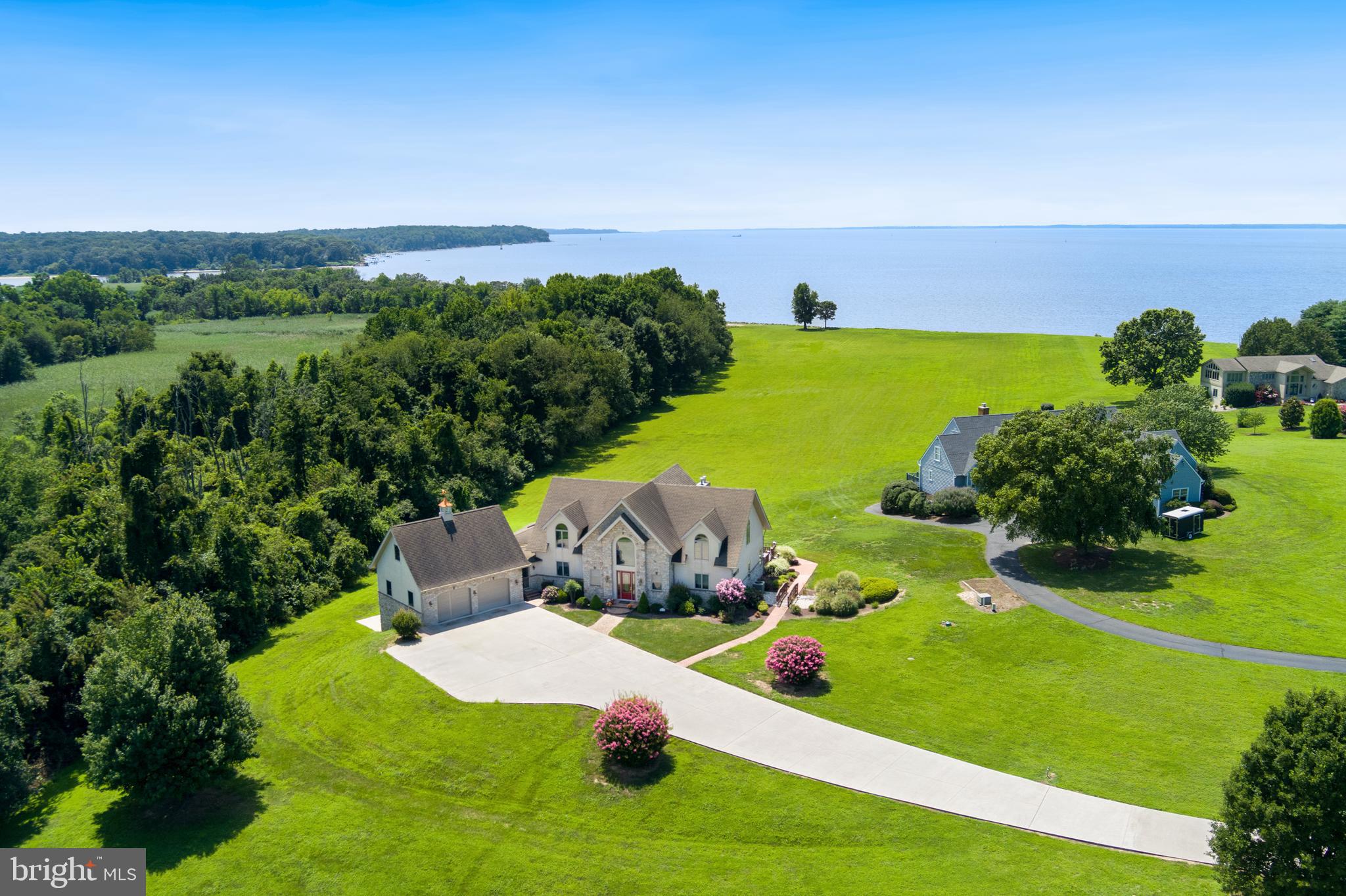 Virtual Waterfront Home on the Upper Chesapeake Bay/Elk River! Enjoy breathtaking sunsets! Experience expansive water views from nearly every room in this exceptional 4 bedroom, 4 1/2 bath contemporary home situated on the banks of the Elk River. Designed for comfort and style, the open floor plan is filled with natural light and features a striking floor-to-ceiling stone gas fireplace in the great room - perfect for cozy gatherings. The main level offers a spacious master suite with its own fireplace, a sliding door to the back deck, and serene water views. The kitchen is outfitted with granite countertops and flows into the dining area and sunroom, both with easy access to the deck. Upstairs, a loft overlooks the water and separates two generously sized bedrooms, each with its own full bath - ideal for guests or family privacy. The finished lower level is an entertainer's dream, complete with a full kitchen, media/theater room, and two additional bedrooms with walk - out access to the covered patio. Additional features include a two - car garage with an upper storage area, plus a separate rear garage for water toys and equipment. A deeded boat slip with lift at the community beach is included - perfect for enjoying all the river has to offer.
