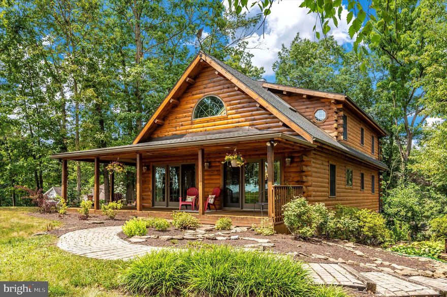 Welcome to this beautiful log home located in a picture perfect setting! You do not want to miss out on all that this Lake Meade property has to offer. Situated on a corner wooded lot with a great view of the lake, this three bedroom, three full bath home features an open floor plan with cathedral ceilings, skylights, beautiful floor to ceiling stone fireplace, first floor owner’s suite, loft, sunroom, fully finished lower level, and lovely landscaping. Enjoy your morning coffee on the large wrap around covered porch. Tranquility awaits, don’t miss out on your chance to make this house your next home!