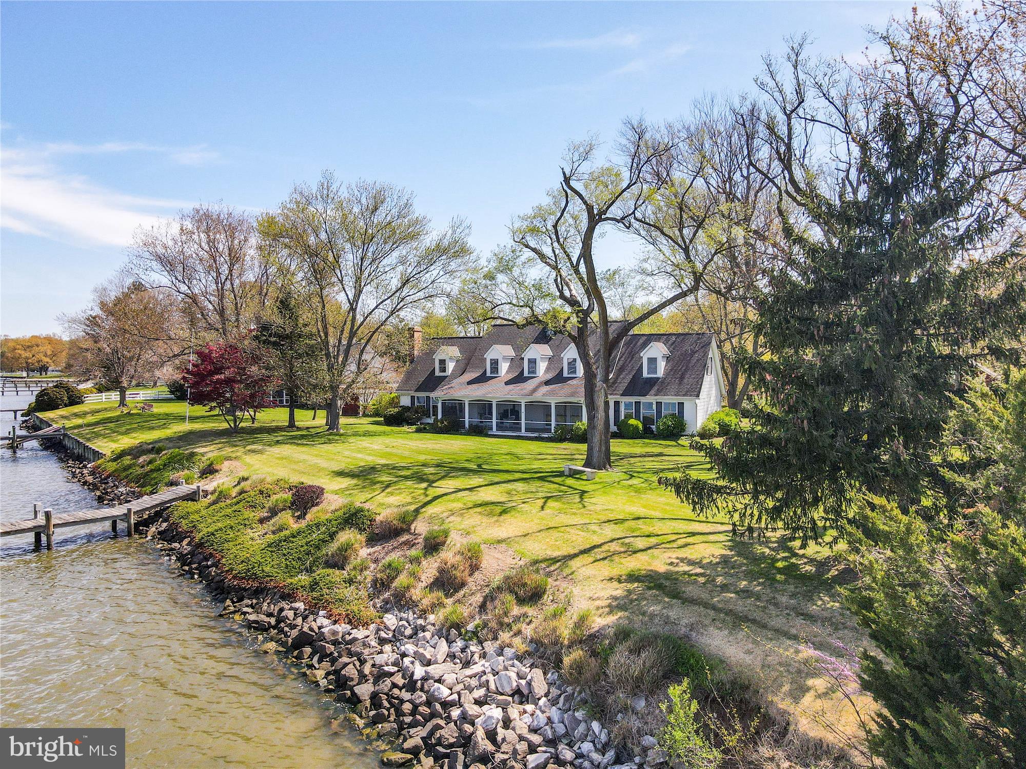 Are you looking for a waterfront vacation property or your forever home? Situated on a peninsula overlooking the West River into Galesville, this gorgeous property offers expansive water views with 5' MLW and 190' of shoreline. Custom built-in 1987 this property was the site of the “Old Hartge Piano building”, where a small section of the old building still remains. This home offers Oak hardwood floors, solid wood doors, 3 masonry fireplaces, and the primary suite on the main level with his and her closets. The family room is a wall of windows looking thru the screened porch to the sprawling lawn with mature old trees and views of the West River, towards Galesville. Enjoy beautiful Sunsets or the Wednesday night Sailboat races right from the comfort of your screened-in porch. Host all the holiday gatherings from a crab feast to Thanksgiving Dinner, there's room for everyone. In addition to this spectacular home, there is a large two-story Red barn with electricity, a wood-burning stove, and those same expansive views of the West River. Perfect for an Art studio, work from a home office, or workshop. There is even a large garden plot ready to be turned. Additionally, there is a storage shed and tractor shed on the property to house your garden/lawn equipment and tractors. Located just 20 miles from Annapolis and just 37 miles to DC.