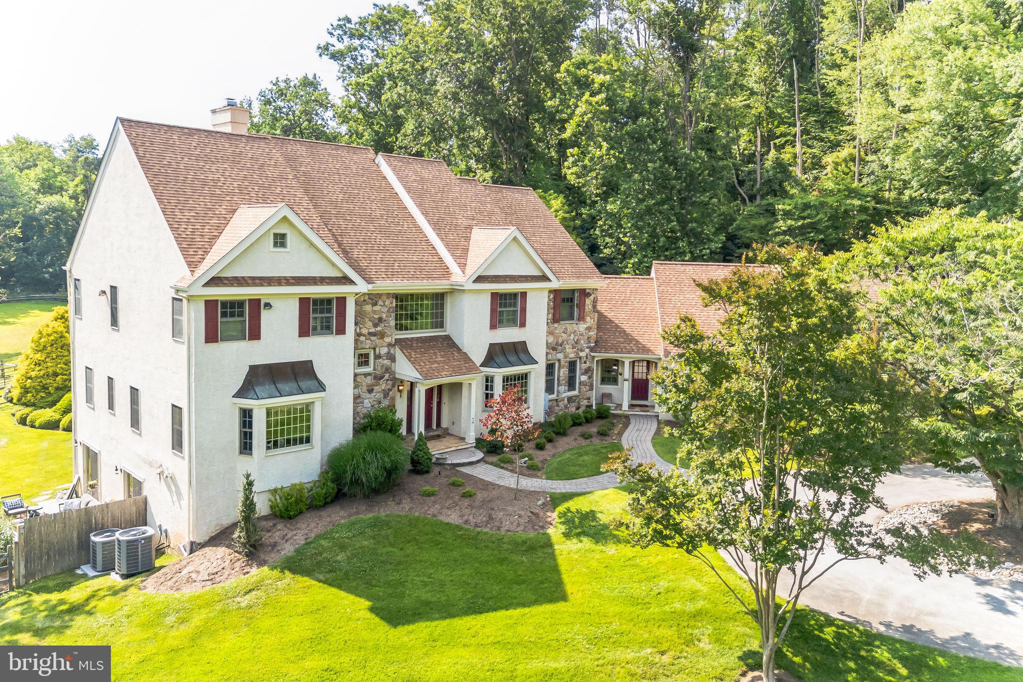 Introducing CRUM CREEK HOLLOW, which is now available for the first time in over 25 years. This stunning estate epitomizes a true Gentleman’s Farm.
The impressive main residence, located at the end of a scenic lane, serves as the gateway to a property filled with delightful surprises. Upon entering, you are welcomed by a breathtaking two-story foyer that bathes the entire home in natural light. Gleaming hardwood floors lead you through a front-to-back colonial layout, featuring a spacious family room with a floor-to-ceiling see-through fireplace and a beautiful screened porch. The office, situated on the opposite side, shares the same fireplace.
The formal living and dining rooms flank the grand entrance, both showcasing exquisite hardwood floors, bow windows, and a formal powder room. The chef's dream eat-in kitchen boasts a Viking 6-burner stove with a griddle, a Brass Venti commercial-grade hood, a dishwasher, double sink, range, and bold granite countertops. The kitchen offers garden views and access to the screened porch, making outdoor dining a breeze.
Additional features include an informal powder room, a washer and dryer, and a cozy sitting room with sliders leading to an expansive deck. The attached three-car garage includes a separate apartment above it.
Upstairs, the elegant master bedroom features hardwood floors and two walk-in closets. The master bath includes a shower, soaking tub, and dual vanities. Three additional guest bedrooms include one en-suite and two sharing a hall bath.
The completely redone lower level boasts beautiful, engineered flooring, a walk-out to a flagstone patio, a stunning horizontal fireplace with a natural wood surround, built-ins, a small kitchenette, and a full bath. An architectural barn door opens to a large storage and mechanical area.
Outside, enjoy the stunning heated pool and jacuzzi nestled among the gardens, with views of your horses in the field or the arena. The property includes a charming three-stall barn with two stories, a hay loft, tack room, wash stall with hot and cold water, and an overhang for shade and farm equipment. Hacking trails are accessible directly from the property.
All of this, and much more, is included with this home, situated in an unbeatable location near the city, hospitals, colleges, schools, arts venues, transit options, roads, and shopping centers.