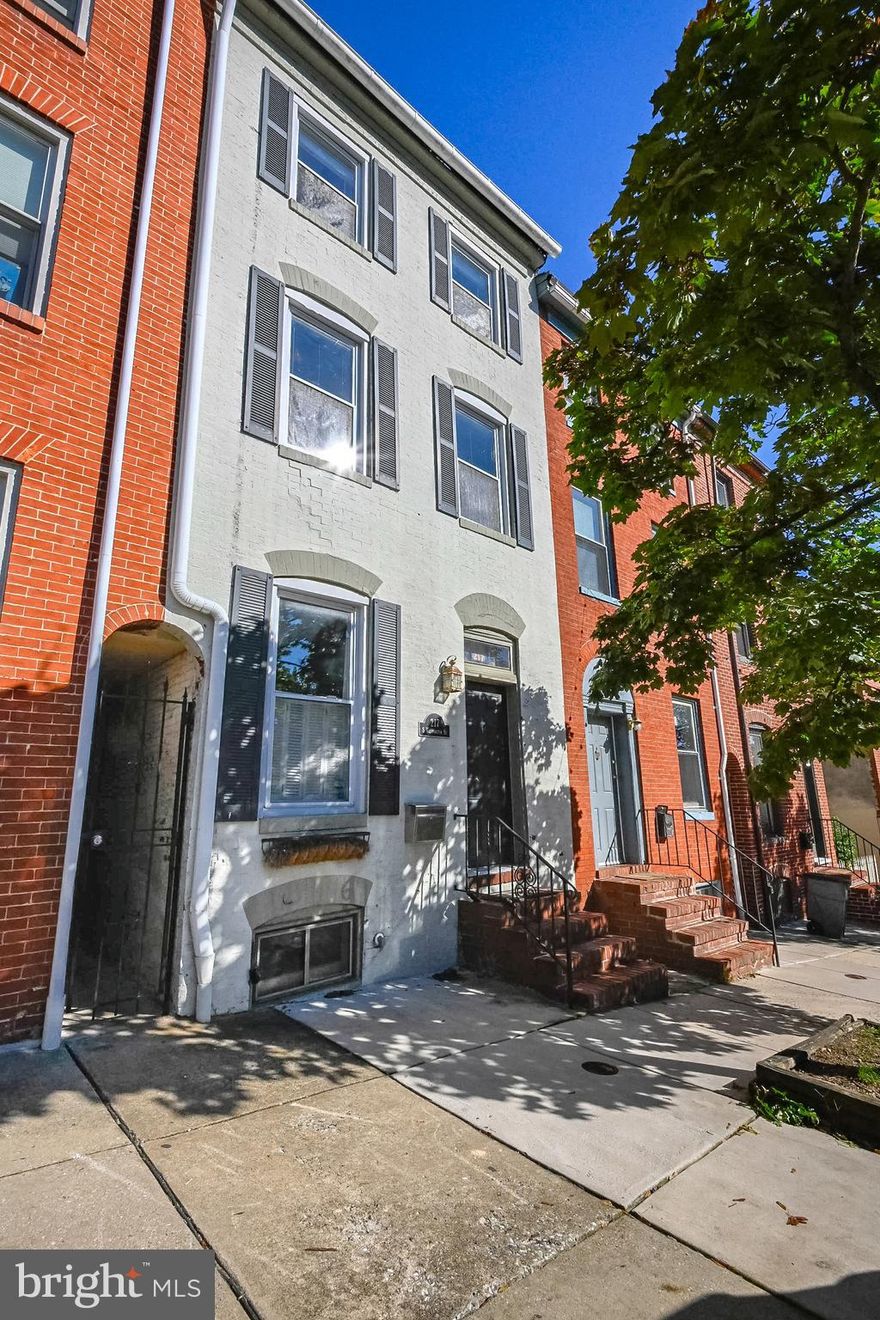Come check out this charming 3 bed 2 full bath townhome in Upper Fells Point! So much to offer, just waiting for the next owners to come add their finishing touches. Original hard wood floors, exposed brick, wood beams, skylights, a large backyard for extended outdoor living space, and views of the city skyline right from your bedroom! New hot water heater  (2020). The first floor offers a living room with fireplace with an abundance of natural sunlight, a large formal dining area, kitchen with island, full bath with stand-up shower, and laundry area leading out to the backyard. The backyard has a patio, along with a grass yard for pets, gardening, or room for kids to play. No back alley for added privacy! On the second floor you will find 2 generously sized bedrooms with a hallway full bath. Third bedroom on the top floor with views of the city skyline from your window. Come update to your liking, add a rooftop deck, and enjoy the beauty of desirable Upper Fells Point!  Within 2 miles you have Patterson Park, Johns Hopkins, Baltimore Aquarium, and many restaurants, shopping and entertainment options to choose from.  1 YEAR HOME WARRANTY INCLUDED!!  Don't miss out on this opportunity! Schedule your tour today. Property sold AS-IS.