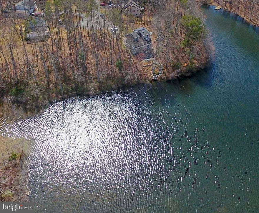 This rare find in Lake Wilderness on Lake Grant is perfect for your new waterfront home! Walk this lot to find laurel bushes and holly trees scattered throughout woodland waterfront property. It's a true piece of paradise. The gently sloping lot is ideal for a walk-out basement to the lake, where you can enjoy fishing in the stocked lake. Convenient access to your electric motored boat, canoe, paddle board and kayak. Soil work was done by the owner, supporting a 3 bedroom septic system. Owner is willing to sell the lot "as is" or contract to build your new custom built home. The community offers many amenities including large pool, pool side snack bar, clubhouse, tennis courts, pavilion, boat landings, volleyball, basketball and security. Lake dredged in 2023. Docks allowed 6' x 24'. But wait, there's more! Lake Wilderness community is convenient to Route 3, where you are minutes away from Fredericksburg shopping, entertainment, historic battlefield sites and I-95. Great school district for the kiddos, too!