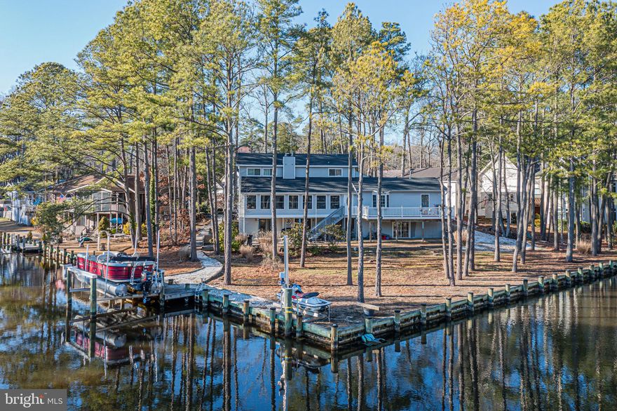 This waterfront home located on a quiet Cul De Sac in the North gate of Ocean Pines, offers over 200 feet of bulkheaded waterfront on a 3/4 acre lot.  This home's amenities include a Jet ski and Boat lift.  The community HOA includes tennis courts, swimiing, golf course and beach club. This home has 4 Bedrooms and 4 bathrooms- 2 primary suites and an in-law suite with a private entry.  A Large waterfront balcony with waterviews off large 4 season room will be great for entertaining and relaxing.  The downstairs level boasts a large room that opens to the back yard. This room has a wood stove and can be used as a movie room/ game room/ den. Seller is offering a $10,000 flooring allowance at closing. You must see this spectacular home on a rare waterfront lot.