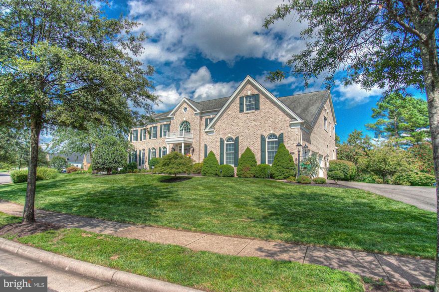 At the gateway between the Metropolitan DC area & the Virginia countryside is the luxury guard-gated community of Dominion Valley Country Club.  Centered in this thriving neighborhood is a signature Arnold Palmer golf course, complete with clubhouse, aquatic & fitness centers, adjacent shopping & dining, walking trails, and many other lifestyle attractions.  In an era where the definition of "home" is constantly evolving, why not select a year-round resort to be your next home.    On arguably one of the best lots in the community, this all-brick center-hall colonial is directly positioned adjacent to the green with sweeping view of the golf course.  Upon entry, you will marvel at the vast expanse of the foyer, flanked by dual staircases on both sides.  A semi-open floorplan hosts the formal living room on the left, dining on the right, with a soaring two-story great room, with coffered ceilings, at the rear of the extended "Hampton" model estate by Toll Brothers.  The grand chef's kitchen offers posh cooking accommodations: granite surfaces, stainless appliances, walk-in pantry, and direct access to al fresco dining provided by the covered & elevated deck overlooking the rear grounds.  The main level is finished with a handsome executive study, brilliant sunroom/conservatory, and a designer powder room.   Upstairs, on the bedroom level, you will find four bedroom suites (all with ensuite baths).  The grand owner's suite features a sitting area, enormous bath, and an even more-grand closet.  Secondary bedrooms 1 & 2 may as well be primary owner's suites themselves considering the size.  An open gallery hall looks upon the great room below, basking in natural light.  The lower level is a canvas awaiting your design.  With space that can accommodate two additional bedrooms, a media room, a wine cellar, a center for wellness & fitness, your options are limitless.  There is a staircase that walks up to the rear lawn, and a dry sauna ready for your surrounds.    In the vicinity to Dominion Valley, you will enjoy countless wineries & breweries, quick access to convenient commuter routes (66) and Dulles Airport, and so much more.  This resort can now be your home, welcome to 15210 Golf View.