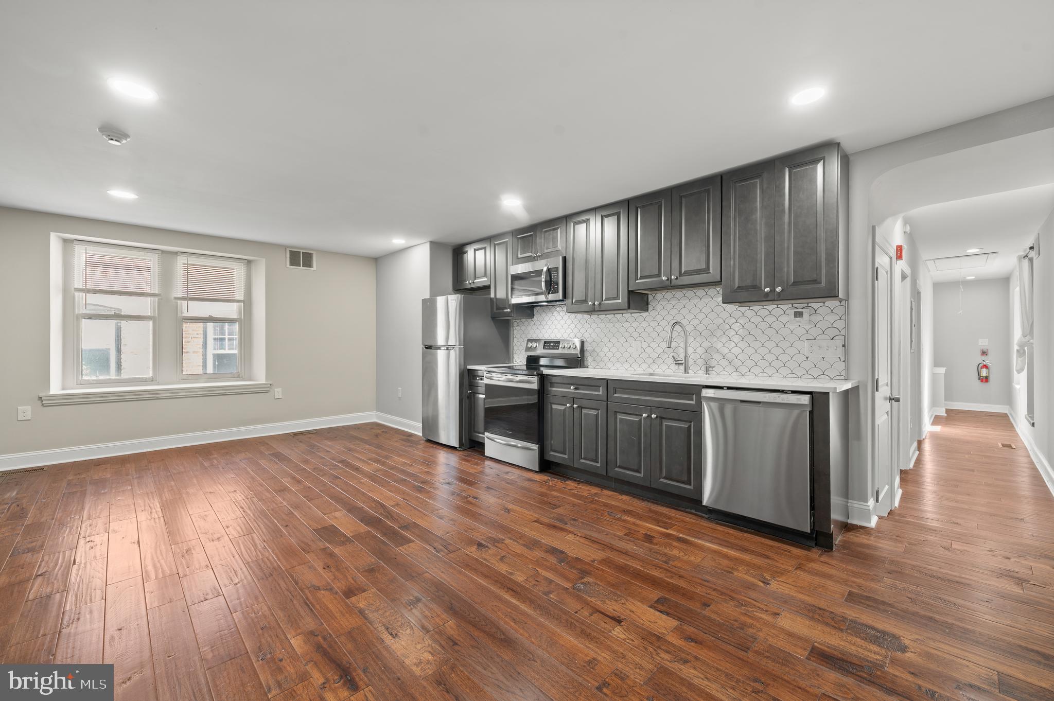 This beautifully renovated 3-bedroom, 2-bathroom apartment is perfectly located in the center of Bryn Mawr, just a short walk to the train, shops, and a wide variety of restaurants. The unit features hardwood and tile flooring throughout, stainless steel appliances including a dishwasher and built-in microwave, ceiling fans, and in-unit washer and dryer for added convenience. Parking available for an additional monthly fee. Enjoy modern living with unbeatable walkability and access to everything the Main Line has to offer.