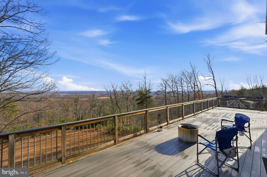 Your search for million-dollar views ends here, beautifully positioned with stunning panoramic views overlooking the mountains, valley, and even reaching all the way to Washington, D.C. With over 3,000 finished sq ft, including 700 newly finished sq ft in the basement, this home offers space, comfort, and thoughtful upgrades throughout.

Inside, you’ll find brand-new flooring across the entire home, fresh interior paint, and an updated kitchen featuring granite countertops and stainless steel appliances (new in 2021). The spacious owner’s suite includes a large walk-in closet, and the home’s bright, open layout is enhanced by beautifully maintained floors.

Step outside to the classic composite deck and enjoy breathtaking views—an ideal setting for morning coffee, evening sunsets, or year-round entertaining. The property is meticulously landscaped and offers complete privacy with no HOA.

The fully finished lower level adds valuable living space with 700 sq ft of newly permitted construction, including an additional 4th bedroom, new rear door, and walk-out access.

This home has been cared for with major system upgrades for peace of mind:
• Brand-new roof (1 month old) with a 30-year transferable warranty
• New windows (6 months old) with a 20-year transferable warranty
• New rear, side, and basement doors
• Septic pumped 1 year ago
• New washer and dryer

.Located in a desirable school district and close to local amenities, this property offers the perfect blend of privacy, convenience, and exceptional views.

A rare retreat. Inside and out.