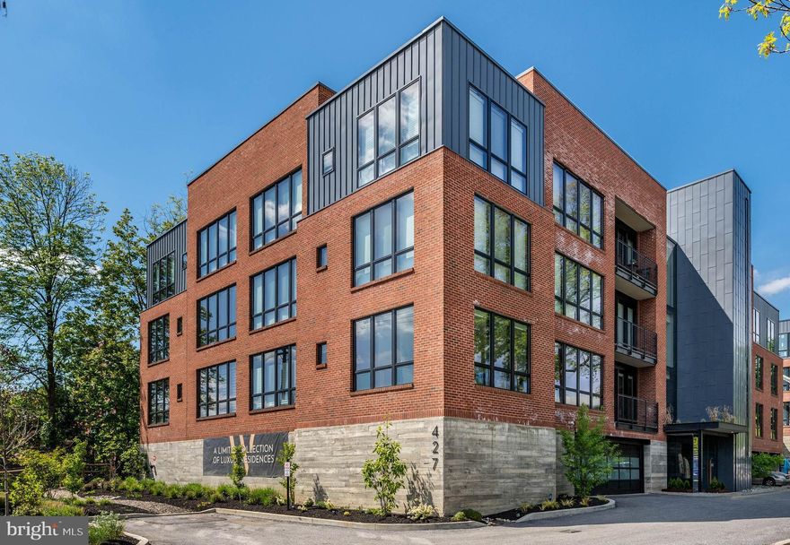 Welcome to Wayne 427, an upscale boutique condominium building that artfully combines the feel of modern city living in a suburban setting. The sleek lobby and furnished landing set the tone for this cutting edge designed 3 Bedroom, 2.5 Bath corner unit. Originally, the builders model, this home has luxury finishes throughout and upgrades galore. Enter into the foyer with double coat closet & convenient Half Bath, and continue to the open floor plan Main Living Area. Floor-to-ceiling windows leading to the private balcony allow an abundance of natural light to enter into this stylish space. The Living Room with custom entertainment center and adjoining Dining Room is the perfect place to gather with family & friends. Blonde hardwood floors and recessed lighting continue to the Kitchen which boasts a floating ceiling, custom two-tone cabinetry, white quartz backsplash & countertops, stainless steel appliances, and an extended island for additional seating. A dramatic hallway leads to the Primary Bedroom ensuite with double vanity & marble surround frameless glass shower, and boasts impressive built-ins, custom closets, and thoughtful details throughout. A second Bedroom is furnished to offer flexible office/sleeping space with built-in desk and Murphy bed. All 3 Bedrooms have electric blinds, ceiling fans, and are nicely separated from the main living area. A Full Hall Bath with floating vanity & marble surround soaking tub, and a convenient laundry room complete the unit. Enjoy opulent, low-maintenance living enhanced by gracious amenities including custom-fitted elevators, keyless entry w/ an invisible motion sensor & remote door unlock, 2 spaces in the underground parking garage w/ Tesla charger that can be converted to an EV, energy-efficient systems, individual storage locker, a well-equipped gym, meeting room, mail/package room, 24/7 emergency maintenance, plus landscaping and snow removal services. Perfectly situated on Lancaster Ave, close to shopping, dining, and in the top-rated Radnor school district. Wayne 427 is a short distance to historic Wayne and an easy train ride to Center City. This stunner won’t last long!