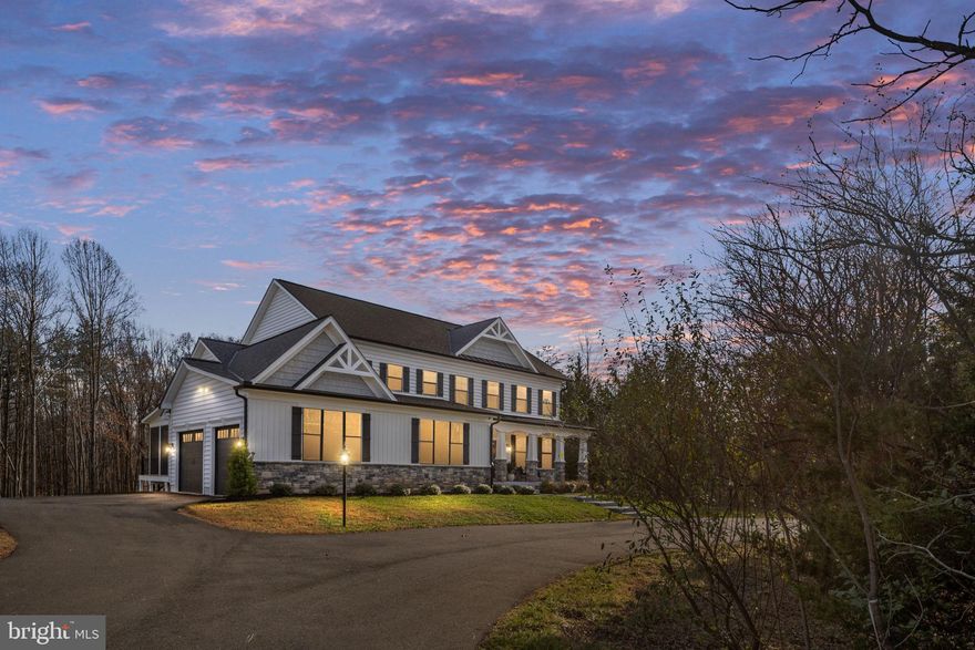 Why wait to build when this gorgeous home is on the market?! Discover refined living at 301 Kingdom Drive in the prestigious Sullivan Reserve of Stafford. This stunning 5-bedroom, 3.5-bath home sits on a corner lot with 3.5 acres and welcomes you with a striking black-and-white exterior accented by stone. Inside, you’ll find 9-foot ceilings on the main, upper, and lower levels, creating an open, airy feel throughout the home. The gorgeous gourmet kitchen features an oversized upgraded window that fills the space with natural light, along with high-end finishes and an expansive island perfect for cooking and gathering.
Hardwood flooring flows through the main level, leading to spacious living and dining areas designed for both everyday comfort and entertaining. The screened porch and adjoining deck offer peaceful views and easy outdoor living. The upper level boasts generous bedrooms, including a luxurious primary suite with a spa-like steam shower. The finished basement continues the home’s bright and open feel with its 9-foot ceilings and offers even more living space, storage, and flexibility.
This property includes a 4-car garage and a whole-home water treatment system, adding convenience and peace of mind. Combining modern elegance with thoughtful upgrades, this exceptional home delivers privacy, functionality, and high-quality craftsmanship in one of Stafford’s most desirable neighborhoods.