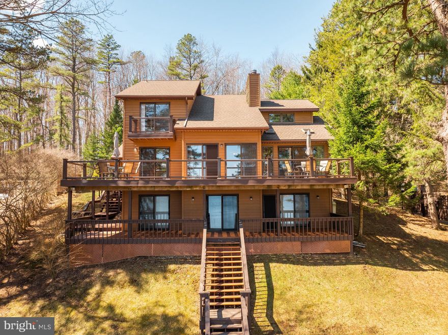 Discover the best of life at Deep Creek Lake in this 4-bedroom (2 en suites), 4.5-bath home. Perfectly situated with a nearly level lawn leading to 91' of lakefront, this property features a private Type A dock and a screened, lakeside gazebo. 
The spacious interior boasts lake views from nearly every room. The home's thoughtful layout includes multiple gathering areas, ideal for entertaining. A floor-to-ceiling stone fireplace is the focal point of the main level living room that opens to the expansive deck. Each bedroom offers comfort, complemented by abundant storage space throughout the home. Downstairs, there is a large rec room that is ideal for games and movie nights. 
Lakefront living doesn't get much better than this! Two levels of decks, recently upgraded with composite decking, provide breathtaking lake views and ample space for outdoor dining.  
Additional highlights include a new roof in 2024 and an integrated 2-car garage with plenty of room for vehicles and lake toys.  
Don’t miss out on this incredible lakefront opportunity! Schedule a showing of this must-see property today!