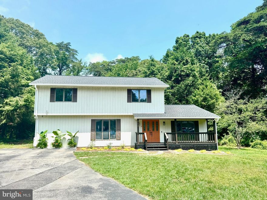 Welcome to 602 Sweet Brush Court, a thoughtfully upgraded 4-bedroom, 3.5-bath home tucked away at the end of a quiet cul-de-sac in sought-after Severna Park. The current owners envisioned this as their forever home and invested in extensive, high-quality updates with care, craftsmanship, and top-tier materials. A new job opportunity is prompting their move, creating a unique opportunity for the next owner to enjoy the thoughtful enhancements they made. The home welcomes you with a charming front porch, refreshed landscaping, and new shutters. Inside, the main level offers a reimagined open-concept layout, where the sun-filled living room features Andersen windows with tranquil views of both the front and backyard. The living room flows into the breakfast nook with a cozy fireplace and access to a private brick patio and a backyard that backs to mature woods. The kitchen includes granite countertops, custom cabinetry, and updated appliances. A traditional dining room sits just off the foyer.  In 2024, the attached garage was converted into a versatile suite with a full bedroom, attached full bath, and separate den, ideal for guests, multigenerational living, or remote work. Upstairs, the spacious primary suite features a massive walk-in closet and a private bathroom with a newly installed low-e skylight. Two additional generously sized bedrooms, one with a walk-in closet rivaling the primary, share a beautifully renovated full bath. The lower level includes a freshly painted walk-up basement with a new Bilco door and stairs, new ceiling tiles, energy-efficient LED lights, and a laundry area with a utility sink and a recirculating pump sized for a future full bathroom. Throughout the home, you'll find energy-efficient LED lighting with dimmable fixtures, smart thermostats, a smart front door lock, and a fully integrated security system. Bathrooms have been renovated with new vanities, updated mirrors and medicine cabinets, and water-efficient fixtures. Additional upgrades include a new 50-year architectural roof with GAF weather-defense synthetic underlayment and oversized gutters (2024), a new 2.5-ton ground-floor HVAC system (2024), and new dedicated 1.5-ton HVAC system, with individual heads for the main level bedroom and den. The chimney was upgraded with a pre-insulated stainless-steel liner, new cap, and exterior access panel. The electrical panel was upgraded to 225 amps, and a Level 2 EV charger was installed in 2024. Enjoy the benefits of a voluntary HOA that includes access to a community pier and neighborhood social events via the Cypress Creek Association. This ideal location is a short distance to the B&A Trail, Severna Park Community Center, local library, and Cypress Creek Park with pickleball, tennis, and basketball courts. Convenient access to Annapolis, Baltimore, and Washington, D.C., and located in the highly desirable Severna Park School District.