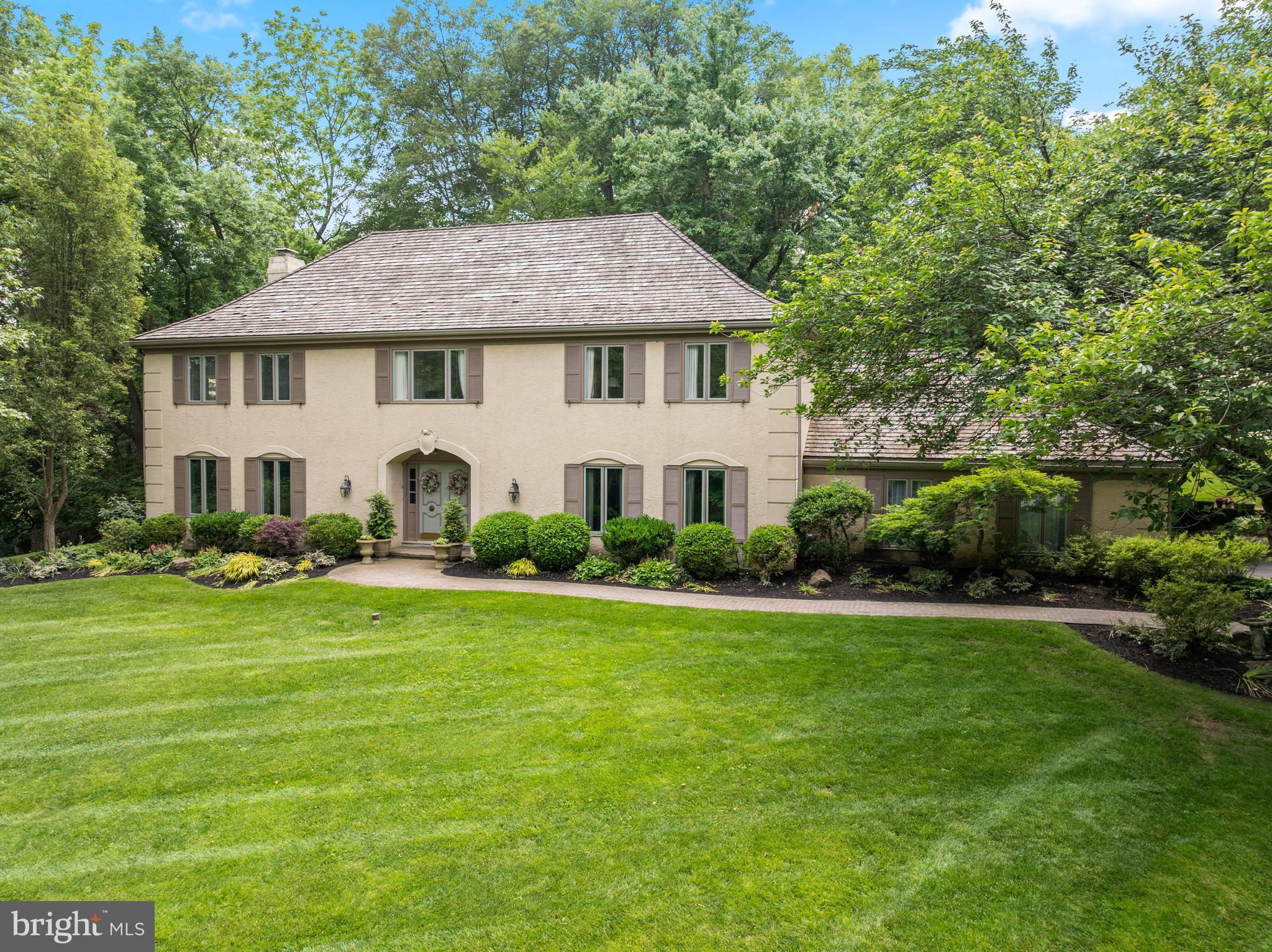 Welcome to 130 Hunt Valley Circle in the bucolic, sought-after neighborhood of Newtown Hunt in Berwyn. This gracious center hall colonial features 4 bedrooms, 2 full and 2 half bathrooms and a finished lower level nestled on a picturesque 1.38 acre lot with public sewer.. As you walk up the pavered walkway and enter through the double doors, you are greeted by a welcoming foyer, with parquet wood flooring and flanked by the living room and formal dining room. To the left is the inviting living room with ample windows to take in the natural beauty outside. The formal dining room is a perfect setting for hosting dinner parties and boasts chair rail and crown moldings. The eat-in kitchen features hardwood floors, white cabinets, stainless steel appliances, built-in desk, and a peninsula with granite countertops. The breakfast room boasts built-ins to house your dishes and cookbooks and has a sliding door to access the lovely covered porch, a great outdoor living space! The charming family room has a beautiful stone gas fireplace with built-ins and a slider to the covered porch for summer entertaining. A 2 car attached garage, a mudroom with washer & dryer and a convenient second powder room complete this floor. On the second level, the expansive primary suite serves as a personal sanctuary, complete with a huge bedroom, a sitting area, walk-in closet, and private office. Indulge in the luxurious primary bathroom, featuring a jetted tub, stall shower, bidet, and double vanity. There are three additional generously sized bedrooms and a hall bathroom with a new vanity and tub/shower combo. The finished lower level is perfect for hosting fun gatherings, like watching football or game night, featuring a large recreation room with a walk-up wet bar and mini beverage fridge. Adjacent to this, a cozy man cave awaits, featuring dedicated wine storage and a wine refrigerator, making it the perfect retreat for relaxation. This lovely, well maintained home offers a unique blend of privacy and community in a private park-like setting & great convenient location! Close to the prestigious Episcopal Academy and award winning Marple Newtown Schools.
