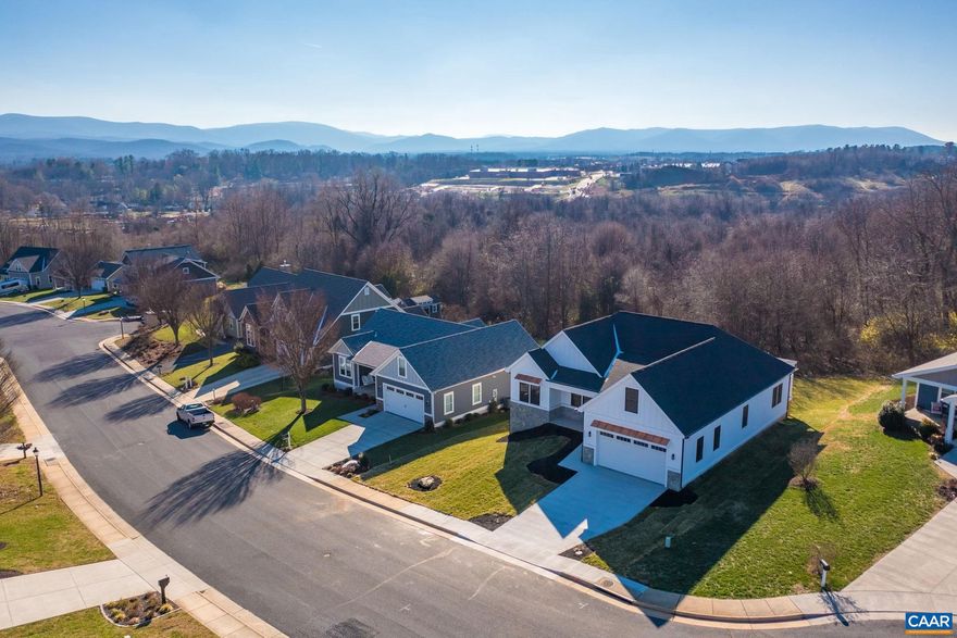 Builder is OFFERING up to $10,000 in CLOSING COST ASSISTANCE! New construction in the desirable Silver Creek subdivision features gorgeous mountain views from the covered porch, highend craftsmanship, high quality hardwood floors, and 1-level living with a walk-out unfinished basement. Meticulously crafted, every detail has been thoughtfully planned for you. Custom features include crown molding throughout the main living area, 9' ceilings, custom colonial trim, hardwood floors, and a large tiled shower in the primary suite. From the welcoming front porch, the main living space is open with comfortable flow throughout, and the spacious covered back porch with privacy panels is great for entertaining or relaxing in the sunshine and enjoying the views. The kitchen features plenty of cabinetry, a large island with sink, and granite countertops. The dining room features a serving area that is convenient to the kitchen. The primary suite features a sitting area and an en suite bathroom with a large tiled shower and garden tub. The bonus room can be used as an office, play area, and more. The walkout unfinished basement has rough-in plumbing, and offers room for shed equipment. Interior pictures with staging are from a similar property.,Granite Counter,Painted Cabinets,Fireplace in Living Room