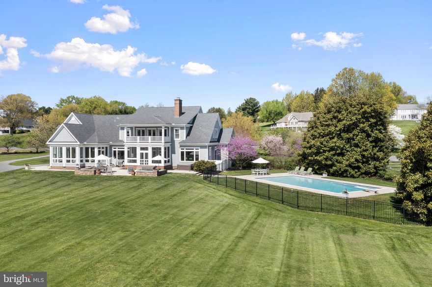 Waterfront living takes center stage the moment you arrive at this stunning two story Southern Living cape cod. The home, built in 2002, is nestled on 3.17 gently rolling acres. The residence captures sweeping views of the majestic Elk River and Inter coastal waterway.

This coastal living home has a natural cedar shake exterior, Brazilian hardwood porches, brick to grade construction, all of which set the tone for the timeless quality that continues inside. The main level unfolds in an open, yet traditional flow, highlighted by 10ft ceilings, extensive crown moldings, a coffered ceiling, Rumford wood burning fireplace, custom cabinetry and Brazilian cherry hardwood floors. Walls of windows frame the ever changing water views and flood the home with natural light. A chef’s kitchen, with gas cooktop, anchors the entertaining spaces. The kitchen, sun room and screen porch, transition seamlessly onto an expansive limestone patio, overlooking the pool and river.

Upstairs the primary suite feels like a private retreat with its own river view balcony, dual walk in closets, spa sized bath; four addition bedrooms and two full baths, provide ample space for family and guests. All interior and exterior furnishings may convey.

Mechanical confidence continues with a six year young dual zone HVAC system with propane back up. A new roof and recently plastered pool add to this well cared for home. A certified septic and termite inspection was completed in 2024.

A three car garage, generous parking pad and long drive make hosting effortless.

The property is a nature lovers dream, with 299 ft of river front, relax on your private sandy beach, kayak, boat, crab or watch the majestic ships pass through the C&D Canal. Bring your boat, and dock in your personal slip that conveys with the property, located on the community pier. Riparian rights, of the waterfront, permits you to hunt waterfowl and apply for your own private dock. Located in the quaint neighborhood of St John’s Manor, residents enjoy modest HOA dues that cover community green space, a private boat ramp, guest pier, and pond access. The bylaws even allow for horses. If you have been waiting for a show stopping waterfront property that blends craftsmanship, comfort and unforgettable views, your search ends here.