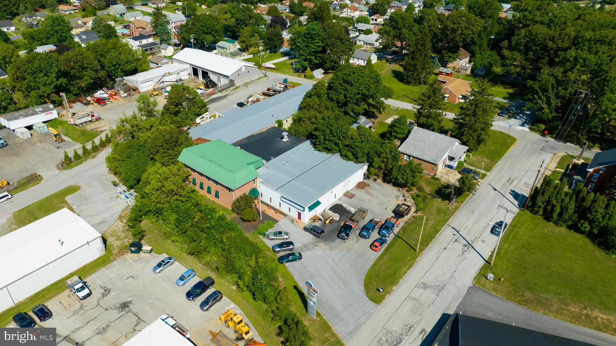 280 N. Park Street is a 23,789 square foot industrial flex building situated on 1.38 acres in Dallastown Borough, Pennsylvania. Located among other industrial and commercial properties, the property offers excellent accessibility, being just 1/4 mile from Route 74 and 4 miles from Interstate 83. The building features a well-balanced mix of finished office space on the first floor, and partially finished office areas on the second floor. The industrial section boasts a clear span fully insulated steel structure with 16’ clear to rafters and 13’ 6” to ceiling, providing an expansive, versatile space for a variety of uses. This area includes one 16’ X 12’ drive-in door, one 8’ X 8’ dock with no leveler, restroom facilities, two offices, and a large paint booth—ideal for businesses requiring specialized equipment or workspaces. The property is equipped with 200A/480V/3Phase power, compressed air, and all public utilities, ensuring that it meets the demands of modern industrial operations.
Additionally, there are two tenant-occupied spaces (2,438 SF and 2,605 SF), which can provide rental income or remain as-is, depending on your needs. The property has twelve parking spaces in the front and ample yard space in the rear, offering room for expansion, storage, or additional parking.
Visibility is a key benefit of this property, with an illuminated box sign on the building and a large pylon sign at the property entrance, offering excellent exposure for any business.
This property is highly adaptable, offering multiple layout options and a range of possibilities for a wide variety of businesses, from light manufacturing to distribution. Its prime location, strong infrastructure, and flexibility make it an ideal investment for both owner-occupiers and investors seeking long-term growth potential.