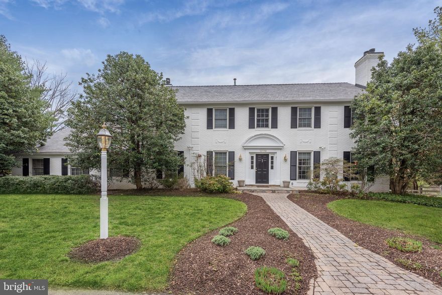 12086 Wetherfield Lane is a classically elegant and wonderfully updated white brick Colonial in the peaceful neighborhood of Lake Potomac. With approximately 2.18 acres, this 5 Bedroom and 4.5 Bath home rests beautifully amongst mature trees and lush grounds. The generously sized rooms are dressed in gleaming hardwood floors, custom millwork, and timeless finishes. Well-proportioned rooms make up the enviable floor plan that showcases 5,300 livable square feet throughout 3 finished levels. There is a circular driveway and an oversized 2-Car Garage. One of the most special features of this home is the backyard oasis that centers around a 41 x 27 saltwater pool and hot tub that is surrounded by a sun-drenched patio.  The Main Level has a 9’ ceiling and begins with a wide and welcoming Foyer that is graced with an eye-catching curved staircase. The Living Room has two large windows and is warmed by one of three fireplaces. The adjoining Dining Room boasts a bay window with views of the Patio and Pool. The Kitchen is well-appointed with stainless steel appliances, ample cabinetry, an adjacent Breakfast Room, and access to the Rear Deck. With a wall of built-ins, a wet bar, and a fireplace, the Family Room is a lovely place to relax and entertain. There is a new Sunroom addition that gives access from the Family Room to both the oversized 2-Car Garage and the rear Deck. A Powder Room and private Study are also on this level.  There are Four Bedrooms and Three Full Baths on the Upper Level along with a Sitting Room and the Laundry Room. The gorgeous Primary Bedroom is comprised of three walk-in closets and a spa-like Bath with a soaking tub, water closet, and separate shower. Bedroom #2 has a walk-in closet and a private Bath. Bedrooms #3 and #4 share a Full Hall Bath.  The Lower Level spans 1,550 finished square feet and includes a Recreation Room with a fireplace and Bar, an Exercise Room, an Au Pair Suite with a Full Bath, and lots of room for storage. This Walkout Level conveniently opens to the Backyard, Patio and Pool.