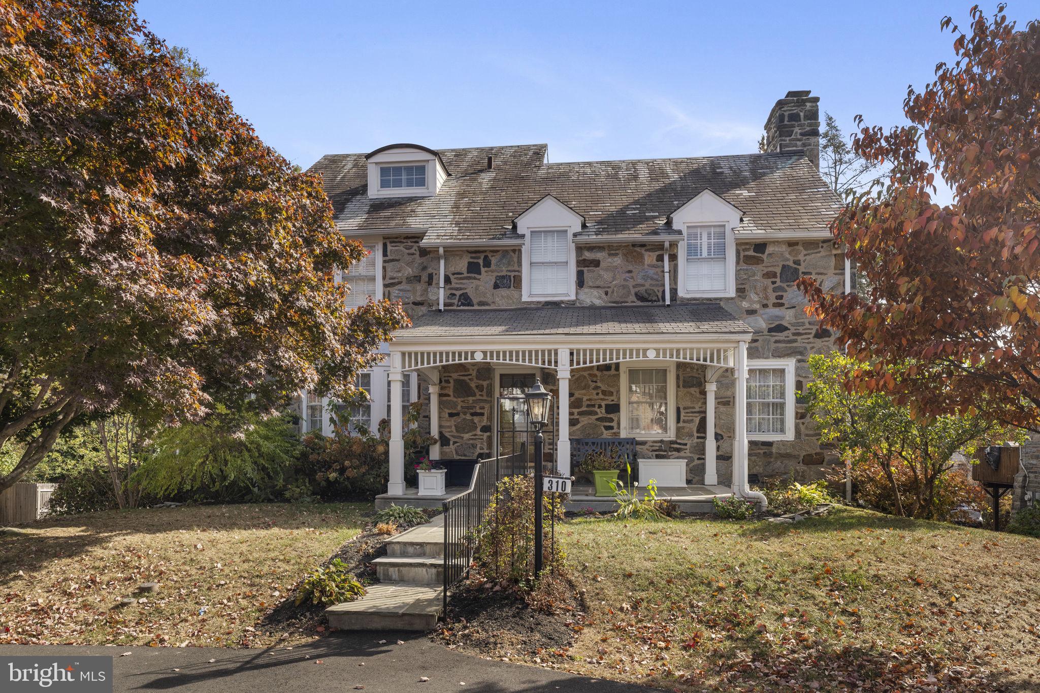 Stunning Stone Colonial
nestled in the heart of Merion Station, this exquisite three-story stone home combines timeless charm with modern amenities. Featuring a covered front porch, private and professionally landscaped rear yard, a slate roof, and a semicircular front drive, this home radiates curb appeal.
Enter through the stained-glass front door into a wide and inviting entry hall. To the right, the large living room boasts a cozy fireplace and recessed lighting, while the dining room to the left showcases a bay window, chair rail, and oak floors. The recently renovated kitchen is a chef’s dream, featuring a tray ceiling, recessed and pendant lighting, double ovens, stainless steel appliances, a large center island with a prep sink and seating, an adjoining breakfast area plus abundant storage. A cozy family room with fireplace provides another family gathering space, just off of the kitchen. A powder room, spacious pantry closet and an oversized hall coat closet complete the main level.
The second floor offers a sunlit landing that leads to the luxurious primary suite, complete with a dressing area, a walk-in closet, and a spa-like bathroom featuring marble floors, double sinks, and a walk-in shower. Three additional bedrooms and a full bathroom are found on this level. Upstairs to the third floor is a 5th bedroom and a full hall bathroom, a hall cedar closet and access to floored attic which provides loads of additional storage.
The walk-out lower level is a versatile space, featuring a large second family room with a stone fireplace, an auxiliary kitchenette, a full bathroom, and room for a home gym or office and laundry room. A Belgian brick walkway from the family room leads to the beautifully landscaped rear yard, offering a serene escape. There is also a one car attached garage.
With its fantastic flow, abundant storage, and prime Merion Station location, this property is a rare find. Don’t miss the opportunity to call this stunning house your home!