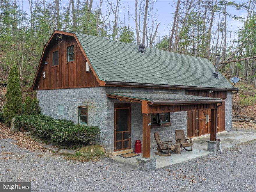 This custom-built cabin sits along the North River, featuring over 900 feet of riverfront and 10.73 acres of rolling hills, trails, and stunning mountain views. The property offers high-speed fiber optic internet, making it ideal for both work and relaxation. The cabin is ready for its new owners, with all contents included in the sale. The versatile space provides endless possibilities—use the two upstairs bedrooms with closets or take advantage of the attic eaves for additional storage. Updated Full Bathroom downstairs, along with a large concreted floor living  area. The property borders the 8,000-acre Short Mountain public hunting and fishing area, offering abundant outdoor opportunities. Hiking trails wind through the land, and a clear-cut section leads you down to the river for easy access to the water. Inside, you’ll find 10-foot ceilings, cedar/ oak trim throughout. Conveniently located just off the main road, it’s only 25 minutes to Wardensville, WV, 30 minutes to Winchester, VA, and less than a 2.5-hour drive to DC. Don’t miss the chance to make this perfect weekend retreat your own! Call today!