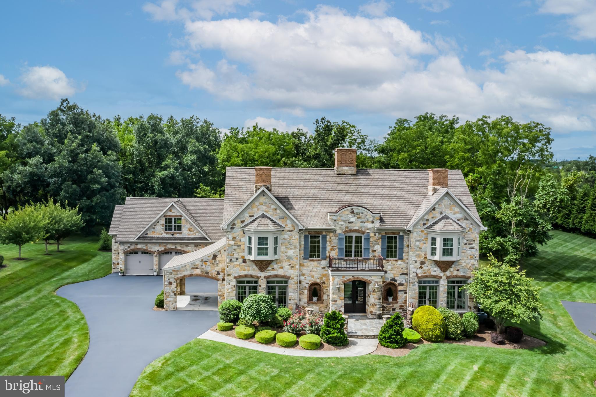 Extraordinary, all stone, Tiday built home in Pinehurst Hills, Hampden Twp., Cumberland Valley schools. Over 8,000 SF of living space, includes 6 BRs, 5 full baths, 2 half baths, and sits on a beautifully manicured, level, .80-acre lot. Begin your tour in the entry way foyer where you will find the dual, main staircase which is sure to stop you in your tracks. Formal dining room connects to the butler's pantry and leads you to the gourmet style kitchen with pantry, double wall ovens, two dishwashers, 6-burner gas cooktop, large island, wine storage, and additional refrigerator drawers. Kitchen has a breakfast room and is open to the family room which features a gas fireplace. First floor In-law suite, or second primary suite, includes a small kitchenette and a bathroom with jacuzzi tub, walk-in closets, and double vanities. Formal living room with fireplace, office, mud room and a half bath are also on the main floor. Make your way upstairs by the main foyer staircase or up the additional stairway from the formal living room. 2nd Primary suite features a gas fireplace and a recently renovated bathroom with double vanities, walk in shower, jacuzzi tub, and walk in closet with washer and dryer. 4 additional bedrooms upstairs, all have their own bathrooms and walk-in closets. Basement is partially finished and includes a home gym, half bath and a bonus room, great place for a playroom or to entertain guests. Plenty of storage space available in the basement as well. Additional features include an oversized 3-car garage and carport for ease of unloading groceries into the kitchen, back yard patio, built-in speakers throughout the home, security system, and so much more! Schedule your private tour today!