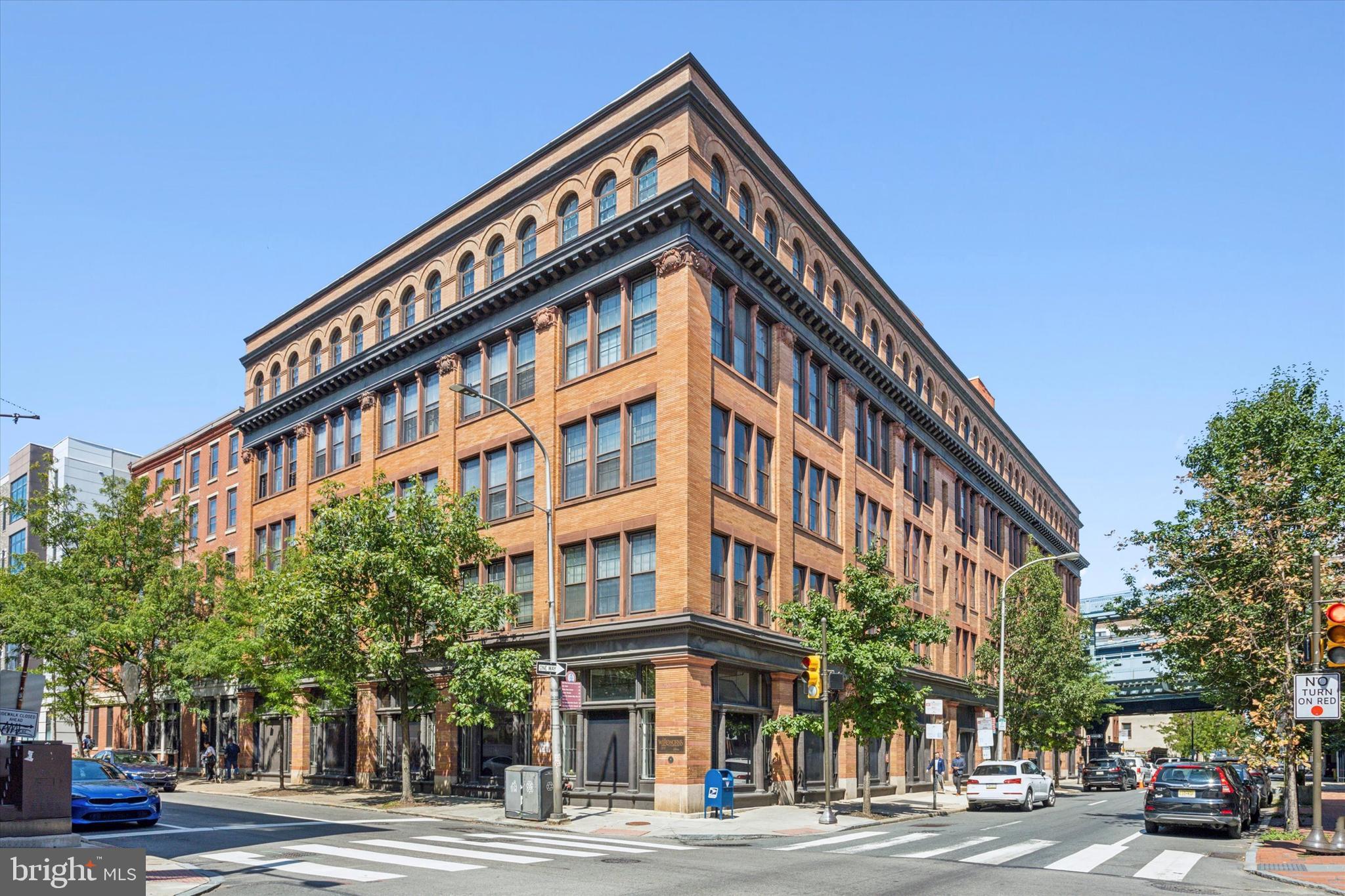 Experience city living at its finest in this charming studio condo at 301 Race St, located in the historic Wireworks building. Enter in through the picturesque courtyard through the secure entry where you are greeted by an open modern lobby area which hosts the mailboxes and package room. The condo is located conveniently on the first floor. This unique space blends modern amenities with industrial charm, featuring exposed wood beams that add a touch of character. The studio boasts a lofted bed for optimized living space, custom built-in shelving and large floor to ceiling windows. There is a spacious kitchen with plenty of cabinet space featuring a stainless steel oven and refrigerator along with a dishwasher. You'll also appreciate the convenience of an in-unit washer and dryer, as well as additional elevated storage within the unit. For those with extra storage needs, there's even more space in the basement along with a bike storage room. This condo is perfect for anyone seeking a cozy, well-designed home in one of Philadelphia's most sought-after locations. Whether you're a first-time homebuyer or looking for a city retreat, this condo has everything you need. Don’t miss the opportunity to make this unique and functional space your own!