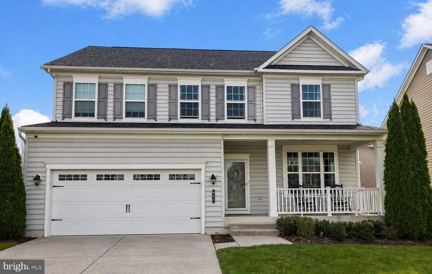 Stunning 4-bedroom, 3.5-bath detached Colonial in the sought-after Residences at Quarry Place offering over 3,700 square feet of finished living space across three spacious levels, including a partially finished lower level with a wet bar. A welcoming front porch sets the tone, while the main level features rich hardwood floors, a warm family room with a fireplace, an open flow connecting the living, dining, and kitchen spaces, plus a convenient half bath for guests. Upstairs, the spacious primary suite offers an elegant tray ceiling and private full bath, while three additional bedrooms share a full hall bath, creating a comfortable and functional upper-level layout. The partially finished lower level adds approximately 1,000 square feet of flexible living space with a full bath, ideal for a recreation room, home theater, gym, lounge, game area, or guest space, with additional unfinished space for storage. A 2-car garage and concrete driveway add everyday convenience. Located in Reisterstown’s Residences at Quarry Place, this well-maintained home offers a commuter-friendly setting near I-795, MD-140, the MARC Train, shopping, dining, and everyday conveniences. An exceptional Colonial with space, style, and flexibility in a desirable community.
