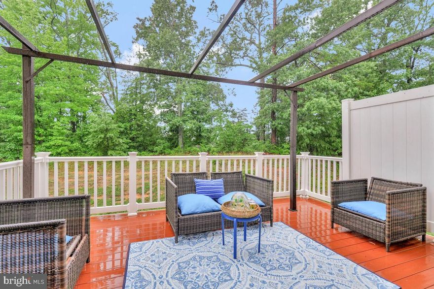 Welcome home to effortless living in this beautifully maintained three-level end-unit townhome with an attached garage, perfectly positioned on a premium lot in the sought-after Gleneagles community in Waldorf, MD. Backing to peaceful wooded land, this rare end-unit offers nearly 2,000 square feet of bright, open living space designed for comfort, style, and easy everyday living.

Step inside to a sun-filled living room that flows seamlessly into a spacious kitchen featuring a large island, rich designer cabinetry, and generous counter and storage space ideal for both casual meals and entertaining friends. The adjoining dining area opens to a composite deck with a large pergola, creating the perfect outdoor retreat for morning coffee or quiet evenings with added privacy.

Upstairs, the roomy owner’s suite impresses with abundant natural light, a walk-in closet, and a private ensuite with dual sinks. Two additional bedrooms and a full bath complete the upper level. The finished walk-out entry level offers even more versatility. Use it as a rec room, guest space, home office, gym, or whatever fits your lifestyle.

Recent upgrades include brand-new stainless steel appliances (2025) and a modern dimmable light bathroom mirror (2024), giving the home a fresh, move-in-ready feel.

Enjoy healthy and active living with Gleneagles amenities: a clubhouse, pool, playgrounds, ponds, and miles of walking and jogging trails. All just minutes from shopping, dining, entertainment, and everything you need.

Don’t miss your chance to own this charming, move-in-ready home with a serene and private backdrop. Schedule your tour today!