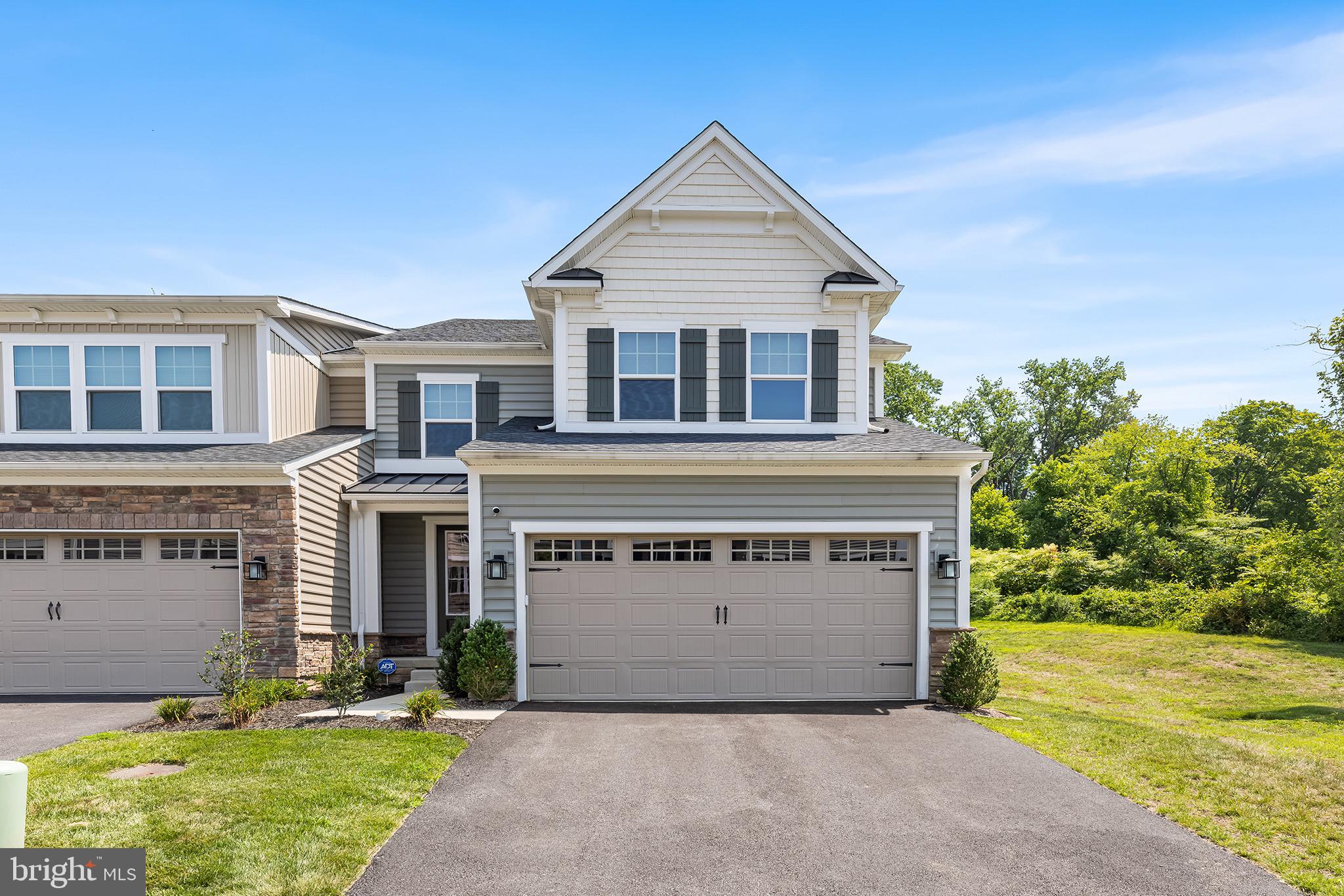 Welcome to 331 Ponds Edge Drive, a gorgeous end-unit carriage home built in 2023 and located in the highly desirable Ponds Edge community in Media, within the top-rated Rose Tree Media School District.
Tucked toward the back of the community on a premium lot backing to a wooded area, this home offers privacy, peaceful views, and extra sunlight thanks to its end-unit position. Inside, you’ll love the bright and airy open-concept layout, high ceilings, and gas fireplace that make the space feel both cozy and modern. The kitchen is a showstopper with upgraded cabinets and appliances, ideal for both daily living and entertaining. Step out onto the rear deck for your morning coffee or evening wind-down. Upstairs, you’ll find a spacious loft that’s perfect for a home office or bonus seating area, plus a convenient second-floor laundry room. The primary suite is a true retreat with a spa-like en suite bath, featuring a tile shower with dual shower heads, and a massive walk-in closet you’ll fall in love with. The finished basement adds even more versatility with an additional full bathroom, great for guests, a playroom, gym, or home theater. With 3 bedrooms and 3.5 bathrooms, this home has all the space and style you need—with the low-maintenance ease of newer construction. Don’t miss your chance to own this nearly-new beauty in one of Media’s most sought-after communities!