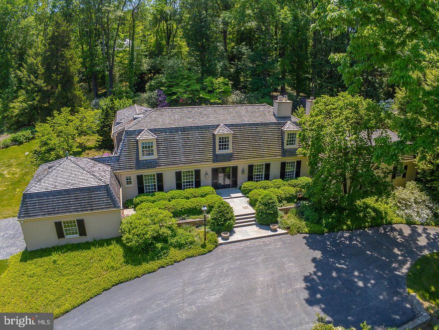 Tucked along a private lane, on one of the most coveted streets on the Main Line, sits 237 Atlee Road.    A semi-circular driveway and a grand stone entry welcome you to this spectacular property with superb craftsmanship, exceptional attention to detail, and sprawling lush gardens.  The grand entry hall is a gallery of refined architectural details, with soaring windows, curated art lighting, and an elegant expert milled staircase.  The foyer leads to the main living spaces and luxurious master suite, all with stunning views of the gardens, stone patio, garden pool and woodland garden; the perfect backdrop for time spent with family as well as formal gatherings. The custom designed gourmet kitchen is a chef’s dream and opens to the grand family room with gorgeous coffered ceiling and sweeping views.  A fabulous butler’s pantry with mahogany and brass accents adjoins the formal dining room and living room. The well-appointed master suite is on the main level with an adjoining sunroom/office overlooking the garden pool. It features hardwood floors, a charming wood-burning fireplace, a dressing room with solid Cherry wardrobes, and a luxurious marble ensuite bath with solid Cherry vanities, stall shower, soaking tub and radiant heat floors. The upper level has an office and three additional bedrooms, two bedrooms with a Jack and Jill bath, and a fourth bedroom with an ensuite bath. The lower level is partially finished with a half bath and additional storage, and offers plenty of room for expansion.