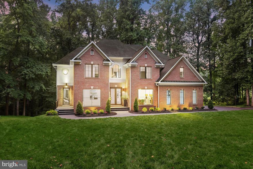 Welcome to 13517 Silent Lake Drive, a modern, luxurious, all-brick single-family residence nestled in the heart of Clarksville, Maryland. This beautiful 5-bedroom, 4.5-bathroom home is perfect for families seeking a serene and elegant living experience. Situated on a sprawling 3.18-acre lot, this property offers plenty of space for outdoor activities and entertaining, with parking for up to 10 vehicles. The surrounding landscape provides a private, tree-filled setting, making it a true oasis for nature lovers. As you enter this stunning home, you'll be greeted by soaring ceilings on the main level, complemented by floor-to-ceiling casement windows that allow natural light to flood the space. The wide plank hardwood flooring, modern trim, and custom baseboards add a touch of sophistication to the home's design. The stunning kitchen features quartz countertops, a waterfall quartz center island, a five burner gas cooktop with a retractable downdraft system, custom cabinetry, and decorative pendant lighting. It also includes a convenient wine room, perfect for entertaining and showing off your wine collection. Adjacent to the kitchen, the large family room boasts a new gas fireplace, creating a cozy atmosphere for family gatherings. The formal dining room, enhanced with elegant new lighting, provides a lovely space for hosting dinner parties and special occasions. The spacious primary bedroom features a sitting area and a dual-sided fireplace, while the luxury primary bath includes a standalone soaking tub, a large glass-enclosed shower, an upgraded vanity, and a walk-in closet. Three additional graciously sized bedrooms, a dual entry bath, and an en suite bath complete the upper level. The lower level offers a fifth bedroom, recreation room, bonus room, sitting area, full-size windows, full bath, storage, and walkout access. Outside, the expansive deck, large patio, and side veranda provide endless options for outdoor relaxation and entertaining. Additional top-of-the-line upgrades include a brand-new well and septic system ($25,000). Apraile Air Ventilation System. New gas fireplace in the living room. Two new Restoration Hardware chandeliers. Gorgeous pendant lighting in the kitchen with a new wine room with low iron glass. New fixtures and mirrors throughout the home. New primary closet with custom shelving. All new low iron shower doors in bathrooms. Driveway resealing, a parking pad with a retaining wall, and flower beds. Multiple tree removal. New sod for 2 of the 3.18 acres. New concrete patio. New concrete steps with decorative metal railings allow access to the deck and backyard area. New brick point-up around the home and new pavers for the front of the home. Epoxy garage floors. Dimmers throughout the home and over 100 lights were replaced. Experience the perfect blend of luxury, comfort, and privacy at 13517 Silent Lake Drive. Your dream family home awaits.