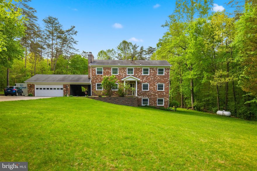 Stately brick colonial home in the secluded and sought-after Greenbrier Estates neighborhood. Situated on a private cul-de-sac, this oversized residence features 4 bedrooms, 2 full bathrooms, 2 Half bathrooms, and a 2-car garage. With over 3,400 square feet of living space on more than 5 acres, the property offers ample room for multi-generational families, including potential for an ADU, a small barn for horses, chicken coop, or parking for an RV, boat, or work vehicles. Notably, the property is zoned A1 with no HOA.

The main level offers a timeless layout with a formal dining room with a wood stove and an eat-in kitchen that flows into a family room with a large bay window. The kitchen includes a French glass door leading to a spacious deck and a beautiful yard highlighted by mature trees and a creek bed that runs through the rear of property.
The second floor contains two spacious bedrooms and a large primary suite with an updated bathroom. The walk-out lower level includes a private entrance, making it ideal for an in-law suite or tenant use. This level features an additional bedroom and bathroom, along with an entertainment area complete with an additional fireplace, bar, tap, mini-fridge, and microwave.
Conveniently located just minutes from I-95, Route 66, 28, 234, and the VRE, this home is perfect for commuters. It is also near historic Old Town Manassas, Shopping, Dining, Great Schools, the Manassas Regional Airport, and local parks like Dove’s Landing,  Prince William Forest Park which offers access to the Broad Run River.

Upgrades 
New shower upgrade in primary bath 2025
Basement bedroom remodel 2026
New attic fan 2024
Replace metal drain under drive way 2018
New ceramic cook top 2011
 New refrigerator 2021
Chimney mortar repair 2024
Leaf guard whole house 
5 new double pane windows   New French doors basement 
New furnace and heat pump 2017
New propane tank 2017
New front door with metal security frame 
Remodel main level