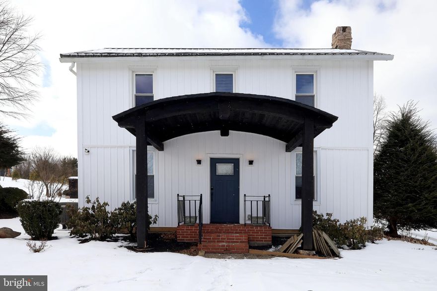 Dating back to 1889, this beautifully restored farmhouse has been completely & tastefully remodeled, preserving its historic charm while embracing today’s comforts. Gracefully positioned on 1.58 serene, picturesque acres, the property captures sweeping panoramic views of the surrounding mountain ranges, a setting that feels peaceful, grounding & truly one‑of‑a‑kind.  From the moment you arrive, the home’s eye‑catching curb appeal, timeless architecture & tranquil surroundings make it clear how much care & intention the owners have poured into every detail. This is a property where history has been honored, comfort has been elevated & the land itself feels cherished. A truly special home, lovingly stewarded & ready for its next chapter.  Sun‑drenched & welcoming, the interior instantly feels like home. The living room highlights original ¾” oak hardwood flooring, recessed lighting, a serene built‑in window alcove overlooking the landscape & a cozy fireplace that anchors the space with warmth & charm.  The dining room blends timeless character with thoughtful design, featuring original oak hardwood flooring & a custom built-in bookcase that enhances both warmth & functionality. With ample space for a large table & seamless flow to the kitchen, it’s an ideal setting for gatherings both large and intimate.  The beautifully remodeled kitchen is a true showpiece, offering crisp white Shaker‑style cabinetry, a classic subway tile backsplash, granite countertops & stainless-steel appliances. A generous center island with additional storage, breakfast bar seating, and striking pendant lighting serves as the focal point, blending classic style with modern convenience as natural light pours in through the windows.  Just beyond the kitchen, you’ll find a practical mudroom & a separate half bath leading to the spectacular two‑story sunroom. Bathed in natural light & framed by soaring ceilings and expansive windows, this remarkable space overlooks the property’s fruit trees and surrounding landscape, a breathtaking place to enjoy every season.  Upstairs, you’ll discover 3 comfortable bedrooms & a spacious full bath featuring luxury vinyl plank flooring, an oversized vanity with ample storage & a convenient dedicated laundry area with additional cabinetry. A full unfinished basement with Bilco doors provides excellent storage & easy exterior access.  The impressive grounds continue to elevate this property with an exceptional collection of outbuildings designed for both functionality & flexibility. A striking 35x28 custom‑built timber‑frame carport with a concrete floor & metal roof offers both architectural appeal & practicality. The 50x25 detached three‑car garage features 10‑foot overhead doors, a concrete floor, half bath, new vinyl siding & a metal roof, ideal for vehicles, equipment, or workshop space.  Adding even more versatility, the 40x24 detached two‑car garage includes future flex space perfectly suited for a home office, in‑law suite, or hobby area. This thoughtfully updated building is equipped with a mini‑split heat pump with central air, separate 200‑amp electrical service, new vinyl siding & a metal roof.  Additional structures include a 48x18 detached building with concrete flooring, new wood siding & a metal roof; a 24x14 detached implement shed with new wood siding & metal roof; and a 28x12 block building, formerly a greenhouse, now topped with a new metal roof.  A distinctive & thoughtfully restored property offering panoramic views, orchard‑like grounds & unmatched versatility, all just moments from Historic Bellefonte & within easy reach of I‑99. This is more than a home; it’s a lifestyle.