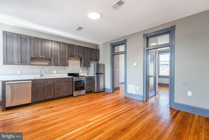 SPACIOUS RENOVATED PENTHOUSE LEVEL APARTMENT IN THE HEART OF FELLS POINT WITH SHARED ROOFTOP DECK AND REAR PATIO! Refinished hardwood floors, updated kitchen w/ granite counters and ss appliances, spacious living area, and 2 bedrooms and 1 full bath. Building consists of 4 apartments and main level commercial space. Tenants share access to rooftop deck and rear garden patio w/ built-in seating. Located in the heart of Fells Point and walking distance to the waterfront, restaurants, and shopping!