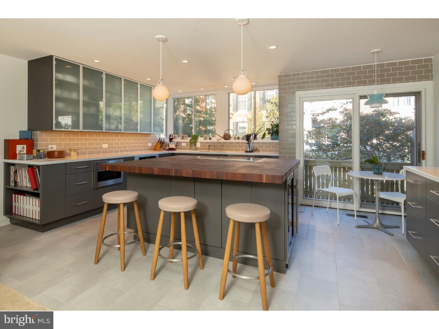 California dreaming in Philadelphia, where the West coast meets the East coast! Modern and dramatic, yet warm and peaceful, the house was extensively redesigned in 2016 by owners' SF Bay Area architect. Expansive landscaped garden, incredible amounts of glass and natural light, balconies and open staircases make this home absolutely stunning. Add to that dual views, front to back, city or garden, your choice! This 3-bedroom, 2.5 bath, 19-foot-wide, split-level beauty is MUST SEE! The entry level features an extra-wide GARAGE and coat closet, a few steps down allows access to the home office with built in desk and bookshelves, a huge walk-in storage closet, half bath, and tile floor. A glass door leads out onto the beautifully landscaped yard that includes a new slate patio, professional landscaping with irrigation system, stone bench and fountain - the ultimate OASIS in center city. The dramatic two-story living room offers soaring ceilings, a wall of windows with natural light and tranquil treetop views, a woodstove, a custom chandelier and a balcony overlooking the yard. The gourmet chef's kitchen features soft-closing wood cabinetry, Corian countertops, tile backsplash, new Thermador & Subzero appliances and a Grouthouse walnut butcher block island with tons of storage. Enjoy meals in the adjacent dining area overlooking the living room and south facing windows. Take in views of the city skyline from the kitchen and another balcony. Next, relax on the sunlit mezzanine with a good book before heading upstairs to the bedroom levels. The master bedroom suite has cathedral ceilings, a walk-in closet, en suite bathroom and linen closet. All the bedrooms have new interior solid core doors. The location couldn't be better with the pulse of the city at your fingertips. Enjoy the proximity to shops, restaurants, cafes, boutiques, theaters, parks and more. Easy access to Penn and 30th street station. Greenfield School Catchment. 10 year tax abatement on improvements. All showings begin at this Sunday's open house 10/28 from 1-3pm. Check OPA for 2019 taxes due to possible citywide reassessment. "Check OPA for 2019 taxes due to possible citywide reassessment."