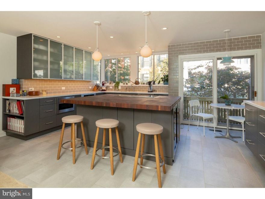 California dreaming in Philadelphia, where the West coast meets the East coast! Modern and dramatic, yet warm and peaceful, the house was extensively redesigned in 2016 by owners' SF Bay Area architect. Expansive landscaped garden, incredible amounts of glass and natural light, balconies and open staircases make this home absolutely stunning. Add to that dual views, front to back, city or garden, your choice! This 3-bedroom, 2.5 bath, 19-foot-wide, split-level beauty is MUST SEE!   The entry level features an extra-wide GARAGE and coat closet, a few steps down allows access to the home office with built in desk and bookshelves, a huge walk-in storage closet, half bath, and tile floor. A glass door leads out onto the beautifully landscaped yard that includes a new slate patio, professional landscaping with irrigation system, stone bench and fountain - the ultimate OASIS in center city.   The dramatic two-story living room offers soaring ceilings, a wall of windows with natural light and tranquil treetop views, a woodstove, a custom chandelier and a balcony overlooking the yard. The gourmet chef's kitchen features soft-closing wood cabinetry, Corian countertops, tile backsplash, new Thermador & Subzero appliances and a Grouthouse walnut butcher block island with tons of storage. Enjoy meals in the adjacent dining area overlooking the living room and south facing windows. Take in views of the city skyline from the kitchen and another balcony. Next, relax on the sunlit mezzanine with a good book before heading upstairs to the bedroom levels. The master bedroom suite has cathedral ceilings, a walk-in closet, en suite bathroom and linen closet. All the bedrooms have new interior solid core doors. The location couldn't be better with the pulse of the city at your fingertips. Enjoy the proximity to shops, restaurants, cafes, boutiques, theaters, parks and more. Easy access to Penn and 30th street station. Greenfield School Catchment. 10 year tax abatement on improvements. All showings begin at this Sunday's open house 10/28 from 1-3pm. Check OPA for 2019 taxes due to possible citywide reassessment.  "Check OPA for 2019 taxes due to possible citywide reassessment."