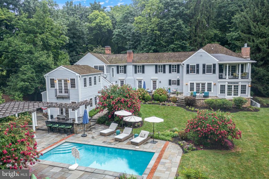 2 Private Way was one of the first manor homes built in Strafford. Nestled on a private lane within the highly sought-after Strafford Village community, this fully renovated home seamlessly blends sophisticated design with a vibrant community spirit.  Enter through the newly designed mudroom, which features custom cabinetry, elegant lighting, radiant heated flooring, and a striking brick feature wall.   Upon stepping inside, you are welcomed by an expansive living room adorned with two sets of French doors and a stunning marble fireplace, perfect for both relaxation and entertaining.  Continue through the hallway to find the gourmet kitchen with stunning countertops, stainless appliances and custom banquette seating, making this the heart of family gatherings. The elegant dining room features inlaid hardwood flooring, French doors that frame the spectacular grounds and custom lighting which enhances the room's open and airy atmosphere. Adjacent to the dining room is the impressive family room which includes custom built-in cabinetry with accent lighting, coffered ceilings, and an inviting gas fireplace, offering a sophisticated space for leisure and entertainment. Ascend the stairs to the second floor to find the owner's suite, a truly spectacular retreat with soaring beadboard ceilings. The suite features a spa-like bathroom with a large dual-head shower, two vanities, a separate soaking tub, and elegant marble flooring.  The owners suite also offers two walk-in closets with pocket doors and French doors that open to a covered private balcony overlooking the private grounds. The second level also includes three additional spacious bedrooms, each with its own bathroom access, plus an additional full bathroom conveniently located in the hall. For added convenience, there is also a second-floor laundry room, streamlining household chores.  Continue down the hall to find the jaw dropping great room, featuring soaring ceilings with custom beams, built-in cabinetry, and a spectacular oversized wood-burning fireplace. This inviting space also includes a built-in banquette and table, perfect for family game nights, and a wall of windows adorned with custom valances, offering abundant natural light and picturesque treetop views.
The basement, with its own outside exit, houses an additional bedroom with a full bath, ideal for an au pair suite or a private guest suite. This level also includes an additional powder room, the home's second laundry room, and a large storage area, providing flexibility and ample space for various needs.
Step outside to the bluestone terrace and enjoy the luxurious amenities to include a heated pool with waterfall and lighting, a separate hot tub, a new pergola with an outdoor television affixed above the wood burning fireplace.  You will also find a large outdoor kitchen area with built in gas grill, sink and a huge granite island with ample seating.   As if all of this wasn't enough, this magnificent property features a separate two-story 1,400 sq ft pool house. The main level of the pool house has a fireside living room, down a few steps to the kitchenette with marble counters, dishwasher, refrigerator, and a full bathroom. Ascend the stairs to the upper-level loft with French doors that overlook the pool area, providing a wonderful area for a w room or can easily be used as a 6th bedroom. The home offers an integral 2 car garage and parking for an additional 5+ cars.   Enjoy the privacy of your expansive one-acre lot, while being part of a vibrant community that hosts a Spring Fling, 4th of July parade, progressive dinners and more. Strafford Train Station is across the street and walking distance to downtown Wayne’s restaurants and shops. The highly ranked Tredyffrin/Easttown School District further enhances the appeal of this exceptional residence.  AFFORDABLE REAL ESTATE TAXES and a rare opportunity to own a house in Strafford Village with the perfect fusion of privacy, luxury and community.