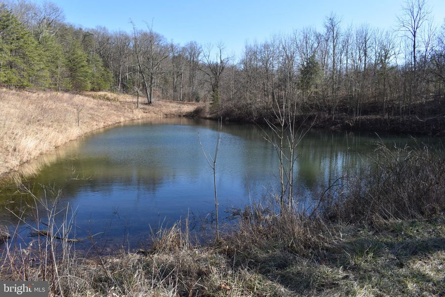 Incredible Perc Approved 9.34 Acre lot with a pond about 1 acre in size.  Lightly Restricted and may be able to be subdivided with Morgan County Hearing and approval.  Multiple great home sites with some overlooking the mountains and some overlooking the pond.  Nice little stream on property feeding pond.  There is a cedar detached garage or run in already in place.  Nice mature timber.  This is a great lot!  Yosemite Lane is a Right of Way and although the neighbors may park along Yosemite, they are aware that this will change when a neighbor goes to build.  They are very nice to deal with and the only neighbor on Yosemite.  Make it home today!  Plat attached to the docs.