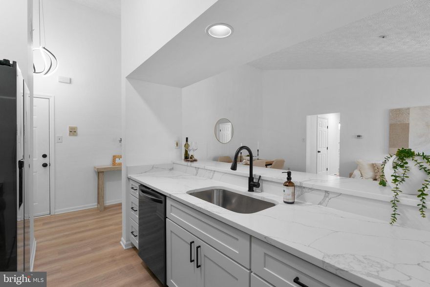 Totally Renovated & Turnkey! This stunning two bedroom, two -bath condo has been beautifully updated from top to bottom. Enjoy a custom kitchen featuring Calcutta Quartz countertops, all-new, black stainless-steel appliances and elegant cabinetry. The open layout is enhanced by wide plank waterproof luxury vinyl flooring throughout. Both bathrooms have been completely redone with stylish, modern finishes. Relax in the bright and airy sunroom or step out onto the covered Trex deck and take in the wooded views-your private retreat awaits. Nothing to do but move in and enjoy!