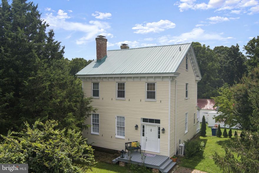 PRICE REDUCED.  This remarkable 1862 home offers modern updates and timeless architecture. The kitchen, thoughtfully renovated in 2019, blends modern convenience with classic style. Inside, you’ll find soaring 10’ ceilings on the main floor, a gorgeous center hall, and gracious dining and living rooms. Historic character abounds with four fireplaces and original wide plank natural wood floors, adding warmth and charm to the living spaces. The stunning staircase is a true centerpiece—open through the center and visible all the way to the top floor.
Upstairs, the second floor features two spacious bedrooms each with its own fireplace, a full bath, and a versatile small bedroom or office space. The top level provides a private retreat with one large room and an additional full bath—ideal as a guest suite, studio, or quiet hideaway. Enjoy the expansive back porch that spans the entire length of the home, overlooking peaceful grounds.
Recent updates include a new metal roof (2019), new 200-amp electric panel, HVAC system, new well pump & Culligan water treatment system (2023), pest-resistant insulation (2017), and new septic system (2004). The home also has electric heat pump splits for zoned temperature control (four units on the main floor, three on the second, and one on the top), plus a pellet stove for cozy, affordable winter heat.
This one-of-a-kind property also carries deep historical significance. Proudly listed on the Historic Registry and situated along the Star-Spangled Banner Scenic Byway, the side-gabled frame house reflects elegant Greek Revival style with fretwork, dentil molding, and natural stone door knobs. A true highlight is the original Coffren Store & Post Office—a two-story frame building with saltbox profile and intact interiors including original shelves, counters, cash drawers, and post office boxes. This rare survivor is an important piece of Prince George’s County’s rural history.
Equestrian enthusiasts will appreciate the property’s historic outbuildings, including a tractor shed with separate stalls, a mule barn, pasture space, a chicken coop (in need of restoration), smokehouse, corn crib, deluxe 3-seater outhouse, and additional barns.
The property is ideally located near 7,400 acres of Patuxent River Park, offering miles of scenic trails for horseback riding, hiking, and kayaking. It’s also convenient for commuting: 40 minutes to Washington, DC; 35 minutes to the Pentagon; 22 minutes to Andrews Air Force Base; and 44 minutes to Fort Meade.
.