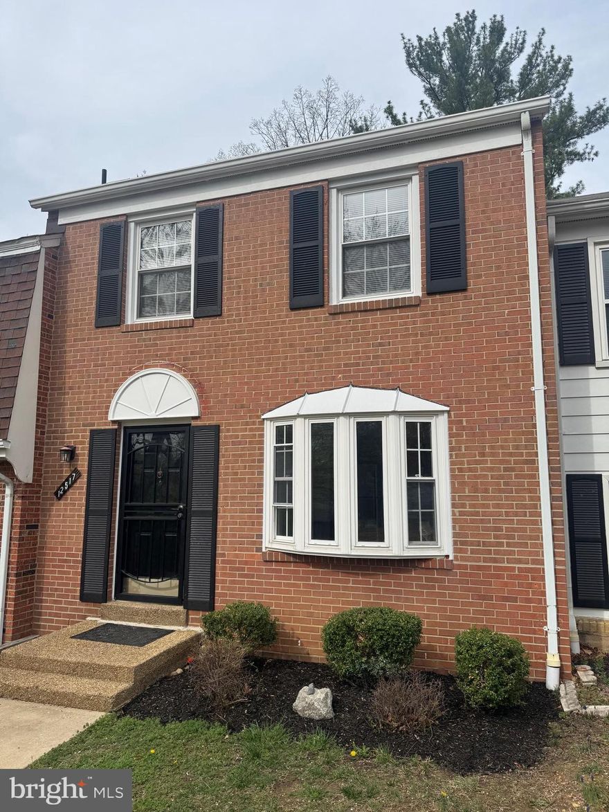 Beautiful brick townhouse in Lake Ridge backing to trees! 3BR 2.5BAs all updated and well maintained...Brand new Kitchen remodel with designer cabinets and high end quartz countertops all tied in with a brand new tile backsplash! Renovated tile bathrooms, tiled to ceiling all with glass shower doors! Updated fixtures throughout! Walk out basement with private backyard! The basement has a large rec room with sliding glass doors to walk out to the fully fenced backyard! A large storage area to help keep organized in basement + laundry! 2 assigned parking spots! Plenty of additional street parking and designated visitor spots! Unbeatable location with community pool, nearby commuter lots and routes, dining, shopping & more!