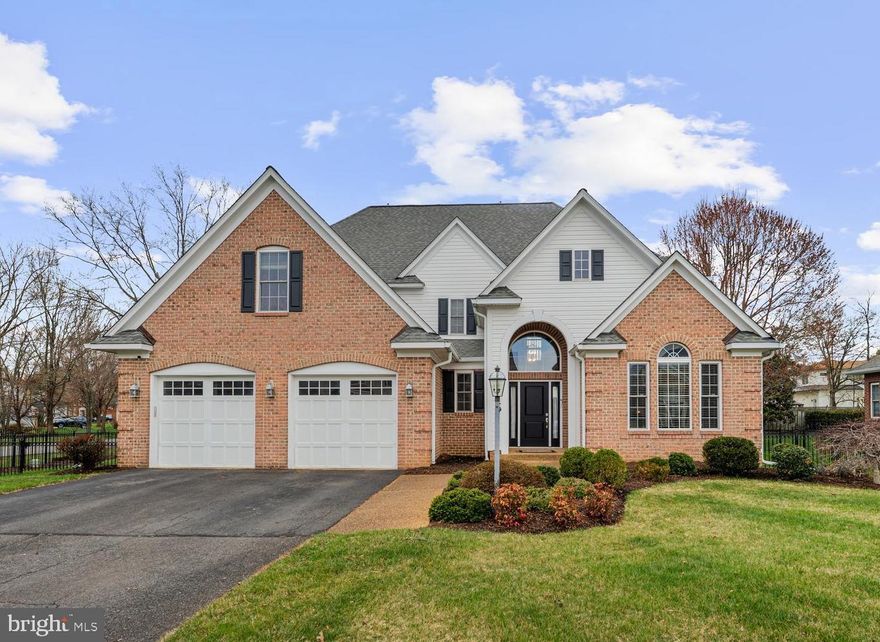 **Assumable Loan with a low 5.125%  rate!*** Welcome home! This stately 3-level brick colonial offers an exceptional and versatile floor plan with not one but two primary suites - including a rare main-level primary ideal for multigenerational living - plus an attached 2-car garage and a detached 3-car garage, making it a truly one-of-a-kind find. Rich hardwood floors, wainscoting, and crown molding flow throughout the main level, where a sun-drenched living room with soaring vaulted ceilings and a beautiful arched window adjoins the formal dining room in an open layout perfect for entertaining. The kitchen shines with stainless steel appliances including a double wall oven, sleek granite countertops, a center island bar with gas cooktop, and a breakfast nook - all open to the cozy family room anchored by a wood-burning fireplace. Tucked at the back of the main level, the primary suite offers plush carpeting, an en-suite bath with a double sink vanity and step-in shower with seat, and its own laundry room - a rare and coveted setup. Upstairs, the expansive upper-level primary suite features a vaulted tray ceiling, plush carpet, and a breathtaking en-suite that is a true retreat, boasting a freestanding soaking tub, luxurious step-in shower, and separate vanities. A generously sized second bedroom enjoys its own private en-suite bath, while two additional bedrooms offer wonderful flexibility for home offices, hobby rooms, or guest space - all served by a third full bathroom in the hall. A conveniently located laundry room rounds out the upper level. The finished lower level extends the living space with a spacious recreation room, sixth bedroom, and fifth full bathroom. A large storage room provides exceptional organizational space, and the overall layout is ideal for a home gym, playroom, home office, or private guest retreat. Step outside to a generous backyard with plenty of room for entertaining, playing, and relaxing, with a patio perfect for grilling and outdoor dining. Out back, the detached 3-car garage offers incredible flexibility for vehicles, a workshop, or extra storage, while the attached 2-car garage and extended driveway provide ample additional parking out front. Just minutes to Safeway, Giant, Kingstowne Towne Center, Springfield Town Center, Old Town Alexandria, charming Del Ray, Franconia Park, and Fort Belvoir. Quick access to I-495, I-95, Telegraph Road, and Van Dorn Street, as well as Van Dorn and Franconia-Springfield Metro Stations. Schedule a private tour of your stunning new home today!