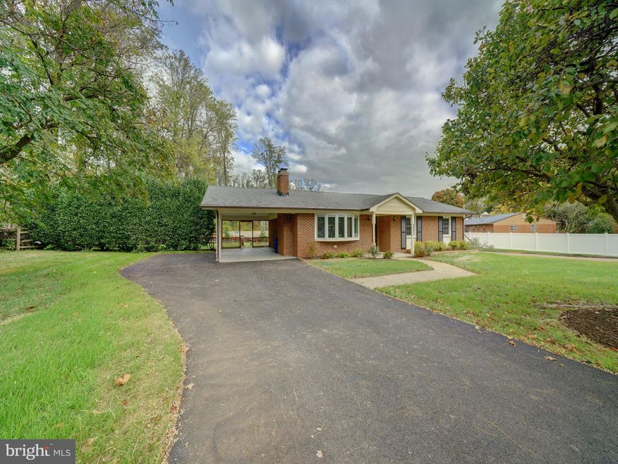 Move right in and enjoy this beautiful all brick rancher in Huntington/Columbia. Located on Vollmerhausen DRIVE, which is off of Vollmerhausen ROAD, this luxurious rancher is nestled among newer homes in the community. Huntington features sidewalks/paths leading to parks, easy access to shopping, major routes, Savage Mill and yet surrounded by streams and rivers with nature trails for your quiet adventures. No HOA or CPRA fees here. The 5 bedroom home has been updated with many upgraded features including gourmet kitchen with wood cabinetry, tiled backsplash, quartz counters & SS appliances, 3 tiled baths, HVAC, roof, windows, doors, composite deck, finished basement, paved driveway, all less than 10 years old. Inside the home is bright with recessed lights, thermal windows and doors providing natural and soft  lighting throughout.  A Pella bay window in the great room and wood burning fireplace provide ambiance to the spacious room. Enlarged kitchen is open to the dining area and there is a counter bar between them. On the main level are 3 bedrooms 2 full baths including the primary suite with private bath. There are hardwood floors throughout the main living area. Downstairs there are 2 more bedrooms with full bath, huge rec room, laundry room with utility sink, storage/utility rooms and the exit door to the rear stairwell. Outside the .25 acre lot is wide and features a large deck, mature trees and access front to back yards from the carport. Versatile carport can be used as a covered porch for additional outdoor living space!