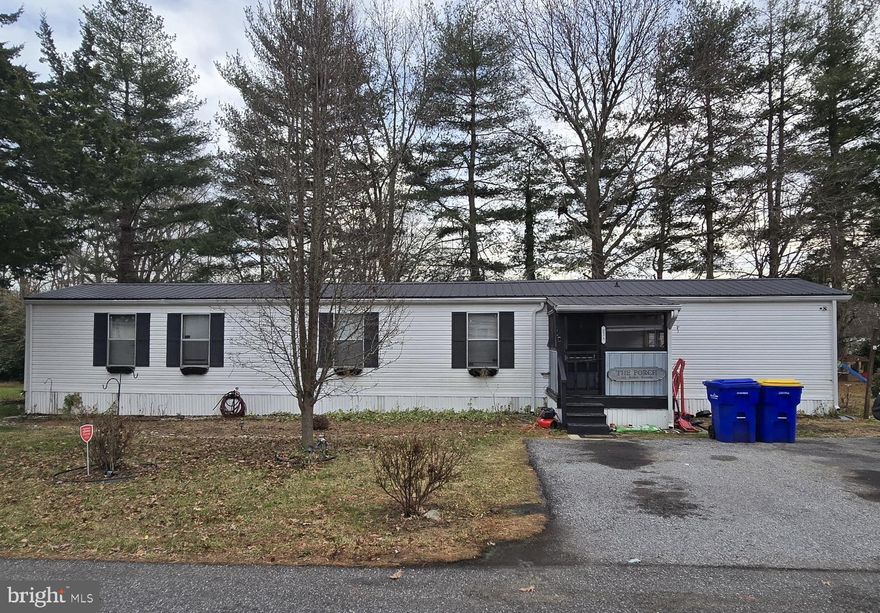 The single wide unit on a spacious tree-lined lot is ready for occupancy. The quiet, park-like setting offers direct access to Route 13, located south of Cheswold and north of Dover.  
 
Sunlight and shade grace this hidden gem both indoors and out. The back yard oasis, enhanced with a wide sundeck, is screened with privacy fencing. Steps away, find outdoor storage.