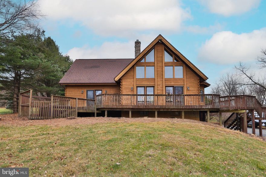 A peaceful 1.5 acre parcel in a picturesque setting for this Barna log home. A hand chopped pine exterior, wood interior with heated floors throughout the main level provide the framework for a home reminiscent of a mountaintop lodge. Brazilian cherry floors and a 24 foot ceiling accent the family room anchored by the floor to ceiling stone fireplace and a wall of windows. This home features an open floor plan with a well appointed kitchen with granite countertops, stainless appliances, island seating opening to a spacious dining area. Enjoy a first floor master suite with a walk-in closet, jetted tub, and access to the hot tub on the deck. The additional two bedrooms feature cathedral ceilings, exposed beams and plenty of storage. The lower level boasts a walk out office with private entrance and access to the two car heated garage. The wrap around deck that spans most of the home offers great views of the nature surrounds. And to top it off, the entire interior of the home, including the garage, has been freshly painted in preparation of your arrival.
