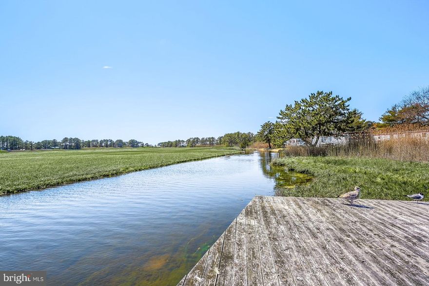 Renovated waterfront 2BR/2BA double efficiency unit at Assateague Inn offering exceptional flexibility and income-producing potential. This rare configuration combines two efficiency units connected by an adjoining door, creating multiple rental strategies — utilize as one larger unit for extended stays or take advantage of the dual layout to maximize occupancy options. Both units feature durable, low-maintenance LVP flooring throughout and share a well-appointed kitchenette complete with a modern tile backsplash and microwave, ideal for short-term guest convenience. The main unit includes a vanity sink and full bathroom, while the adjoining unit offers a spacious second bedroom with its own private exterior entrance — an attractive feature for guest privacy and independent access. Each unit is equipped with separate heating and air conditioning systems, allowing individualized climate control and enhanced guest comfort.  Guests and owners alike enjoy picturesque waterfront views, dock access, and an outdoor pool — amenities that consistently drive rental appeal. Ideally located near charming island shops, local dining, the natural beauty of the refuge, and nearby beaches, this property combines lifestyle enjoyment with strong investment versatility.  A turnkey coastal opportunity suited for personal use, vacation rental income, or both.