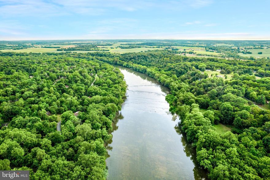 Built in 2022 and set on nearly 4 wooded acres (3.81 deeded acres), this beautifully maintained home offers three finished levels of living space, modern upgrades throughout, and private deeded access to the Shenandoah River, creating the perfect balance of comfort, privacy, and outdoor lifestyle.

At the heart of the home is the open kitchen, family room, and dining area, creating an inviting space ideal for everyday living and entertaining. The kitchen features granite countertops, backsplash, stainless steel appliances, a large center island, and a corner pantry, along with a separate dining space dining area that offers plenty of room for gatherings (featuring custom board and batten wall trim) . The kitchen also opens to a rear deck overlooking the fenced backyard and wooded surroundings, providing the perfect setting for relaxing or entertaining outdoors.

The thoughtfully designed main level offers both functionality and privacy. On one side of the home, the spacious primary suite serves as a peaceful retreat featuring two walk-in closets and a stunning spa-inspired bathroom with double sinks, soaking tub, walk-in shower, and additional storage. On the opposite side of the home are two additional bedrooms and a full bathroom, offering excellent flexibility for guests, a home office, or multigenerational living.

The fully finished walk-out lower level expands the living space even further and includes two additional rooms, a custom upgraded full bathroom, and a large mudroom/laundry area with direct access to the two-car garage and backyard, offering flexible space for recreation, guests, hobbies, or work-from-home needs.

This home stands apart with quality finishes throughout and no builder-grade materials, along with luxury vinyl plank flooring throughout the home with no carpet for a clean, modern feel.

Additional highlights include:

• Hybrid HVAC system (gas/propane) for efficient year-round comfort
• Whole-house generator system providing added security and reliability
• Rear deck off the kitchen
• Fenced backyard backing to woods
• High-speed Comcast/Xfinity internet available
• Two-car garage with ample driveway parking

Located in the desirable John Brown Farms community, residents enjoy private deeded access to the Shenandoah River, perfect for kayaking, fishing, tubing, and enjoying the natural beauty of Harpers Ferry.

If you’re looking for a newer home with acreage, privacy, and modern finishes, this property offers a rare opportunity to enjoy the best of West Virginia living while remaining within convenient reach of Northern Virginia commuting routes.