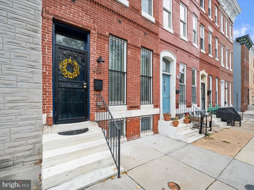 Welcome to this beautifully updated 3-bedroom, 2.5-bath rowhome in the vibrant Station North Arts District! High ceilings, rich hardwood floors, and a neutral color palette create a warm and inviting atmosphere throughout.
The sun-filled living room flows seamlessly into the casual dining area and the well-appointed kitchen, featuring gleaming ceramic tile floors, granite countertops, stainless steel appliances, and a decorative tile backsplash. From the kitchen, step outside to the private,  fenced yard ideal for pets, raised garden beds, or simply enjoying the fresh air. A convenient main-level powder room completes this level.
 Upstairs, two spacious bedrooms share a renovated full bath with a tub/shower and ceramic tile surround, with the added convenience of upper-level laundry facilities. The entire second upper level is dedicated to a private and spacious primary bedroom suite, featuring an updated en suite bath with a double-sink vanity, dual mirrors, and a stall shower with decorative ceramic tile surround.
The unfinished basement provides flexible space for storage or the opportunity to create a customized living area.  With the new roof (and its proximity to MARC and Amtrak lines, Penn Station, and local favorites for entertainment, dining, recreation, and shopping, this home offers an unbeatable combination of style, convenience, and location.